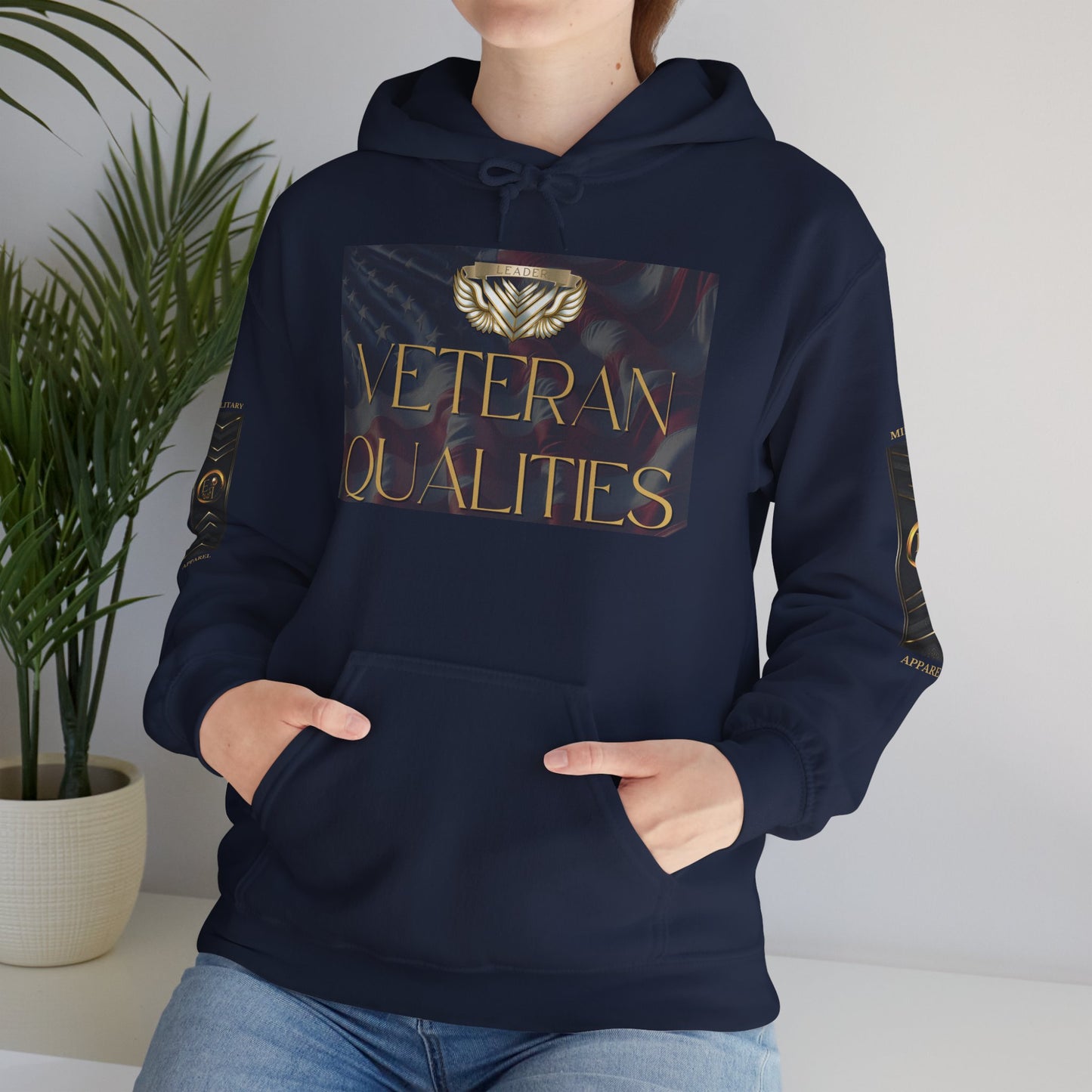 Person wearing a black Essence Innovation hoodie with 'Veteran Qualities' design, standing against a neutral background.