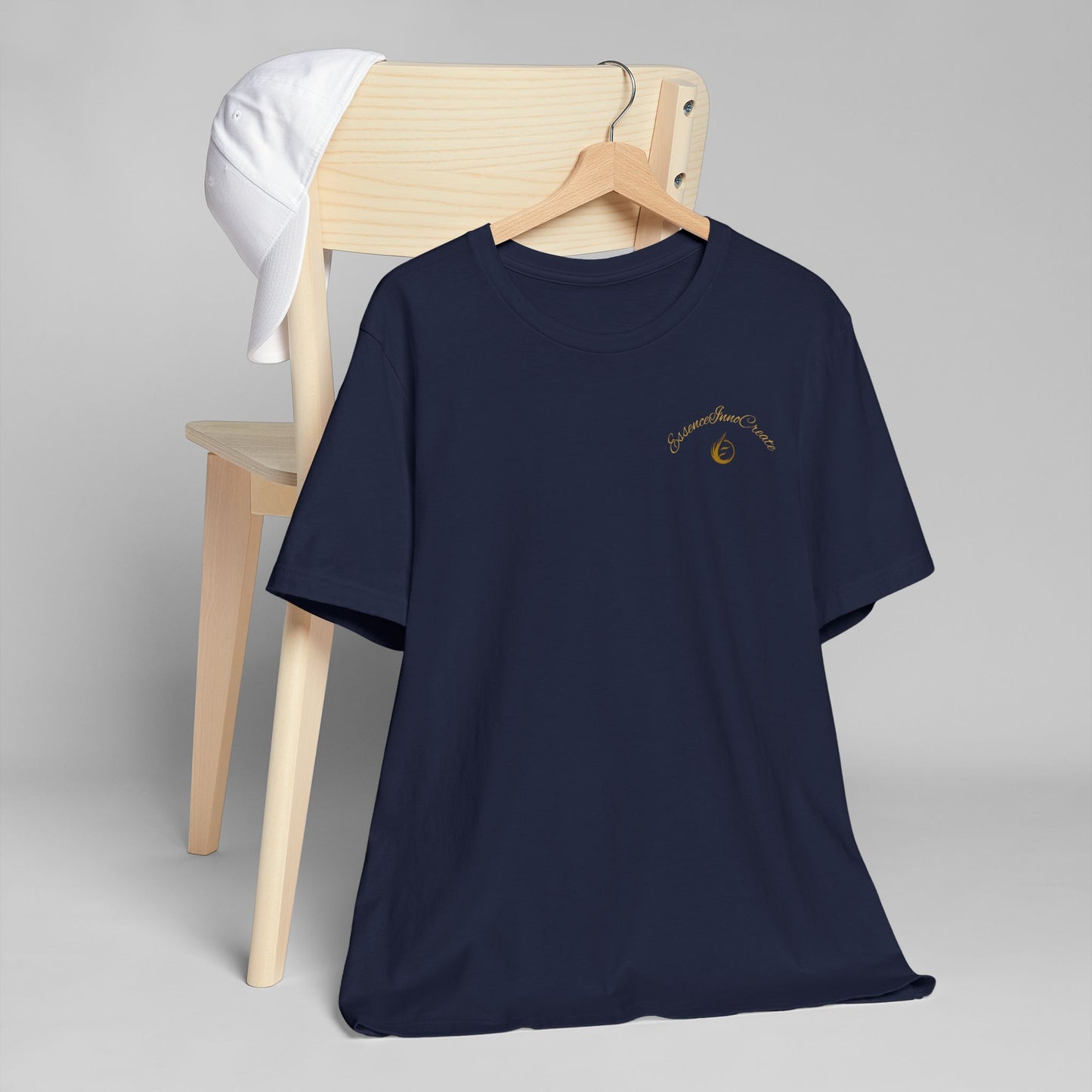 Navy blue t-shirt with 'EssenceInnoCreate' logo on a hanger against a gray background