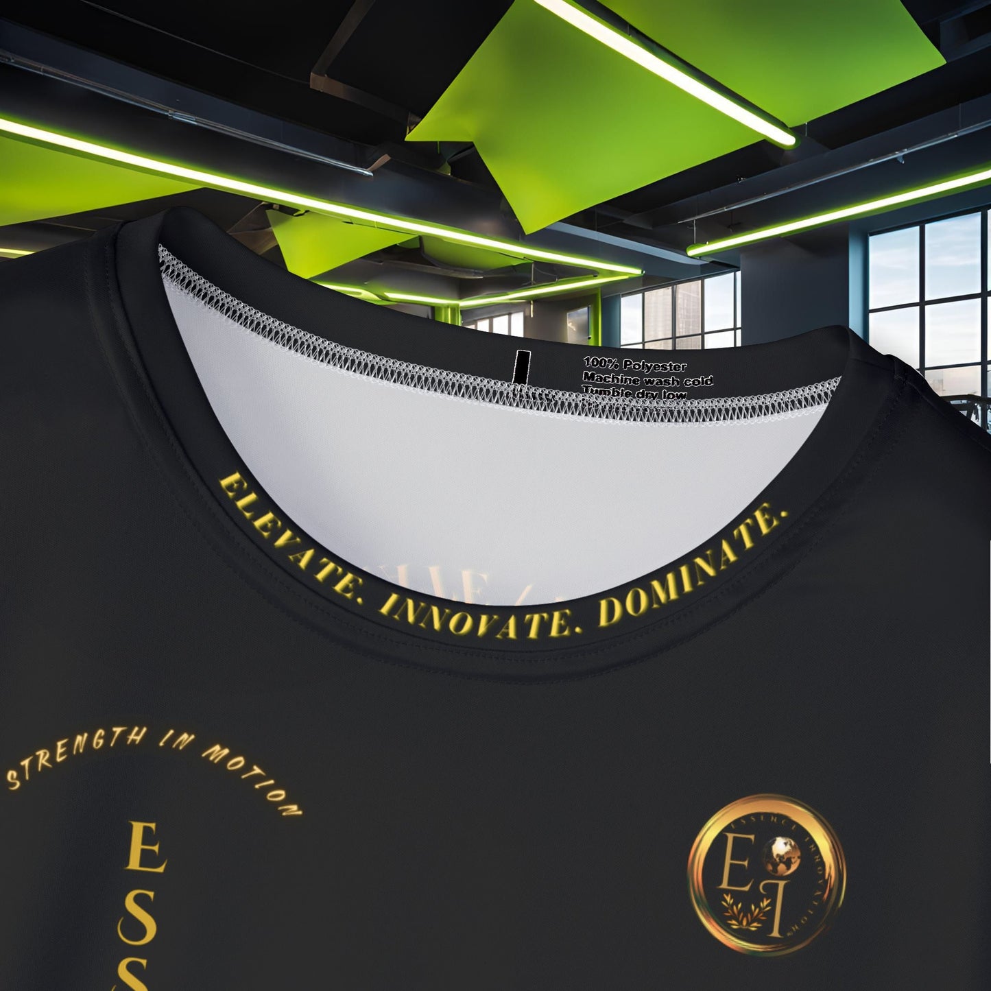 Black t-shirt with gold Essence Innovation logo and text and logo in a modern indoor setting
