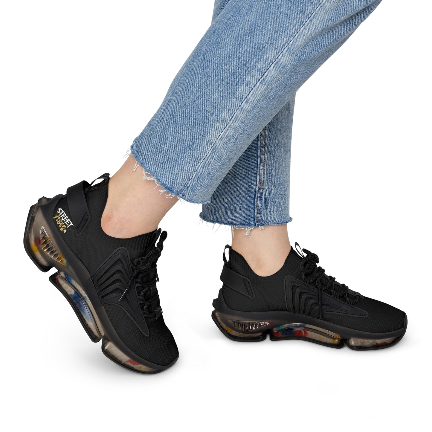 Black Essence Innovation 'Street Vibes' sneakers worn with light blue jeans on a white background