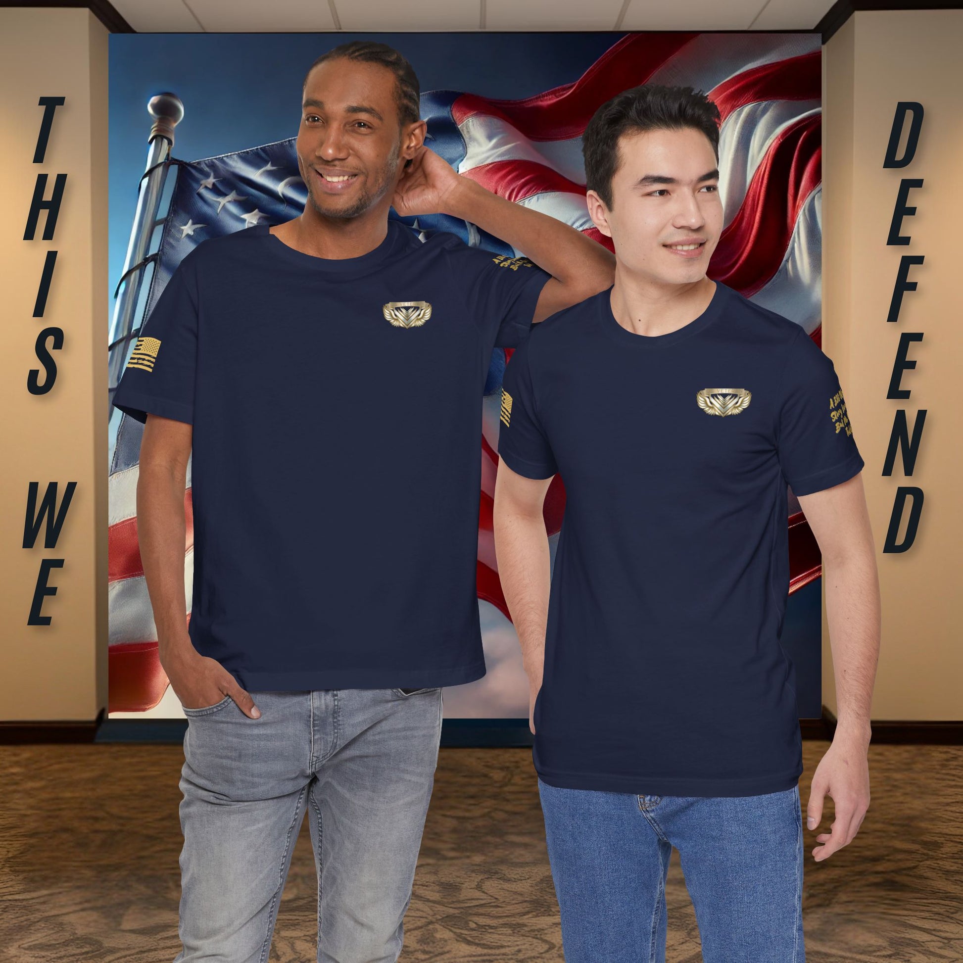 Two men wearing navy blue t-shirts with a logo in front of an American flag background.
