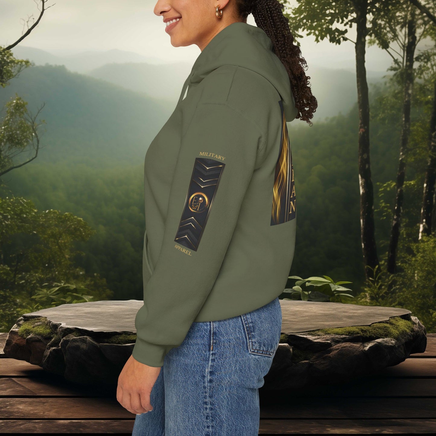 Person wearing a green Essence Innovation jacket with EI Military Apparel patches in a forest setting