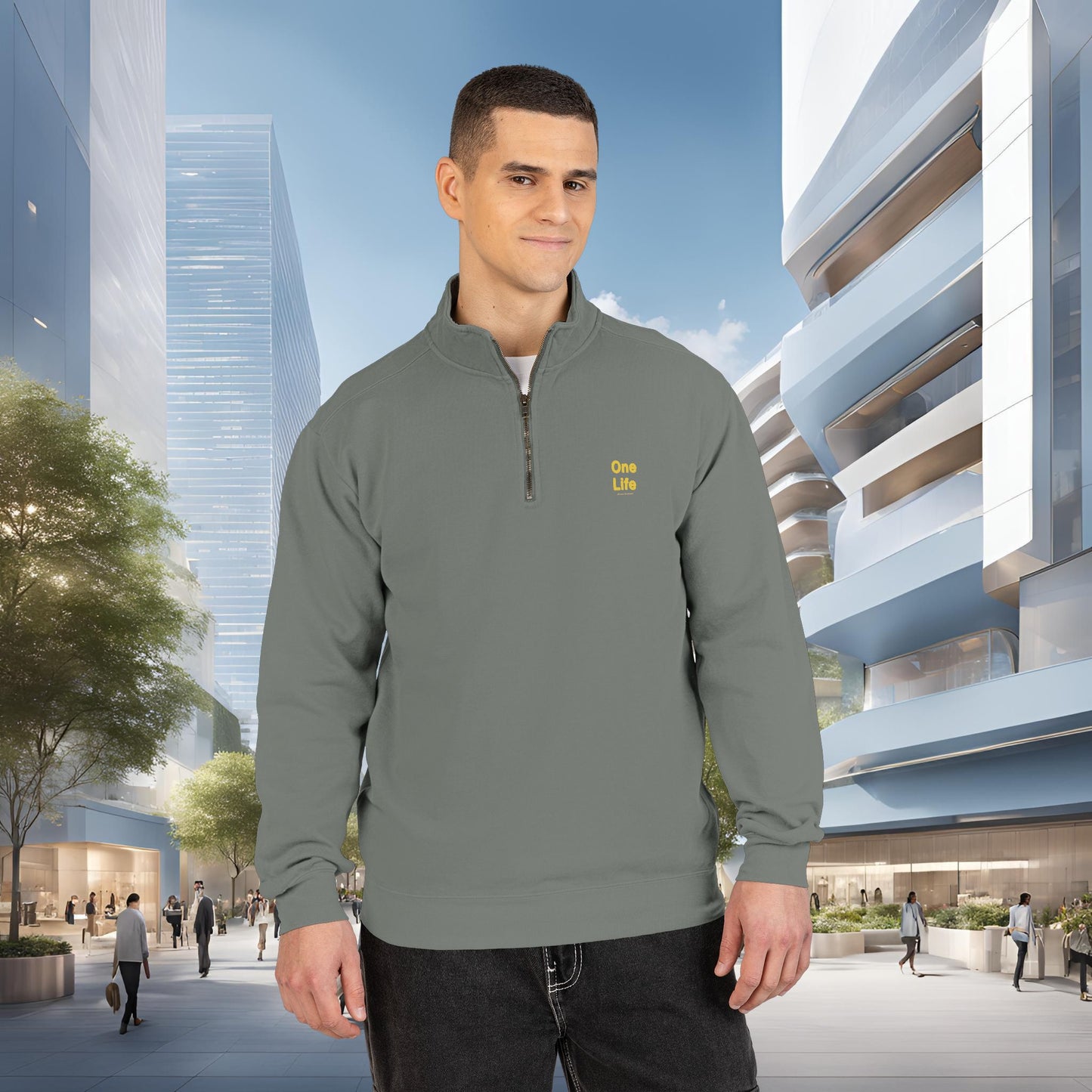 Man wearing a gray pullover with a One Life logo in an urban setting