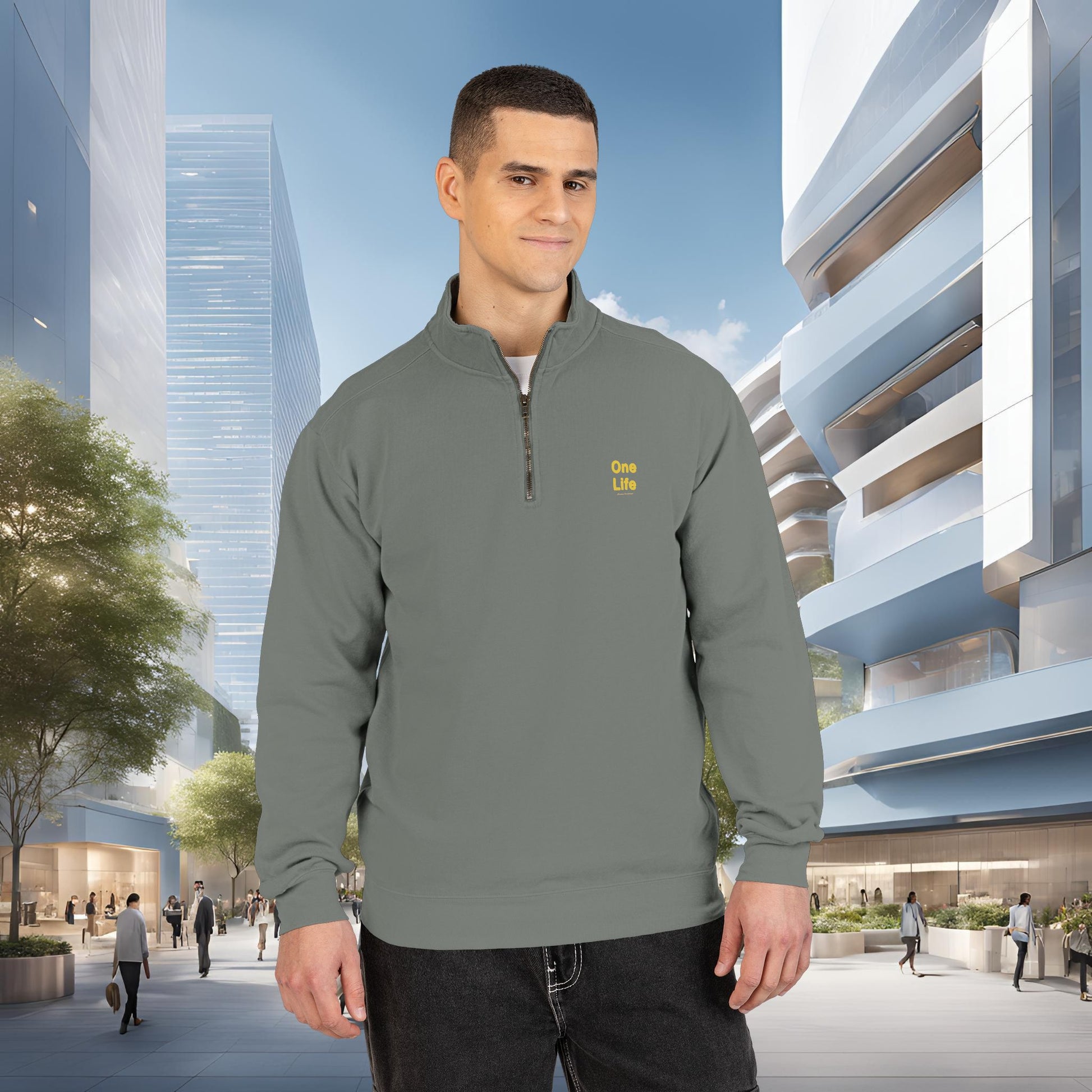 Man wearing a gray pullover with a One Life logo in an urban setting