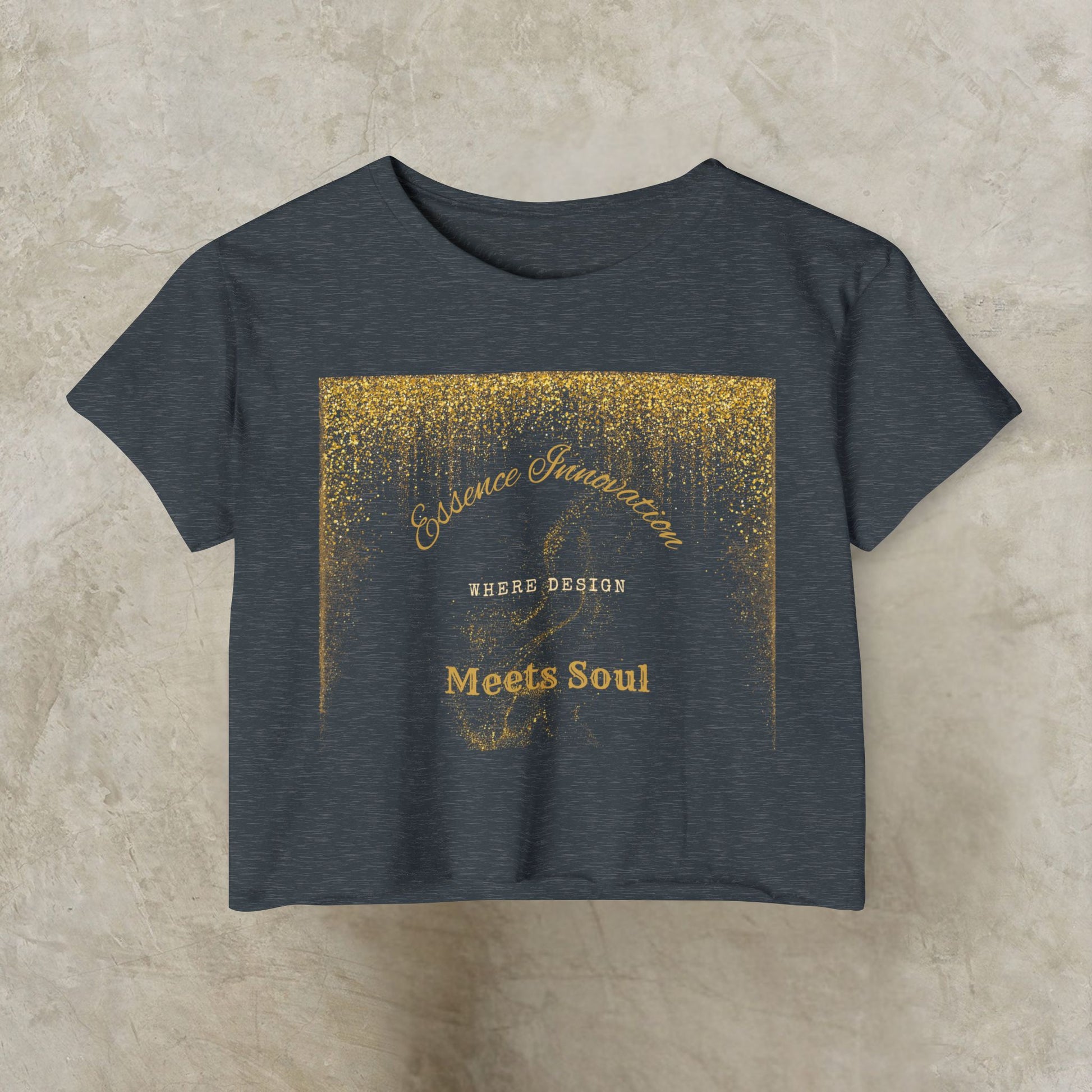 Dark gray t-shirt with gold Essence Innovation 'Design Meets Soul' text and design on a beige background
