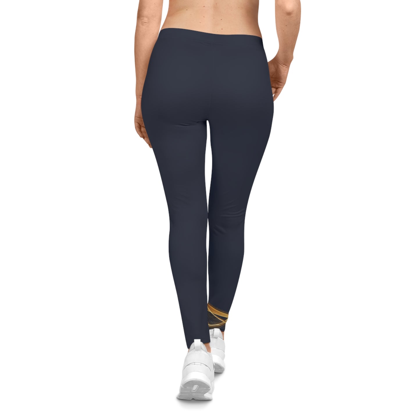 Person wearing navy leggings with a gold accent on a white background