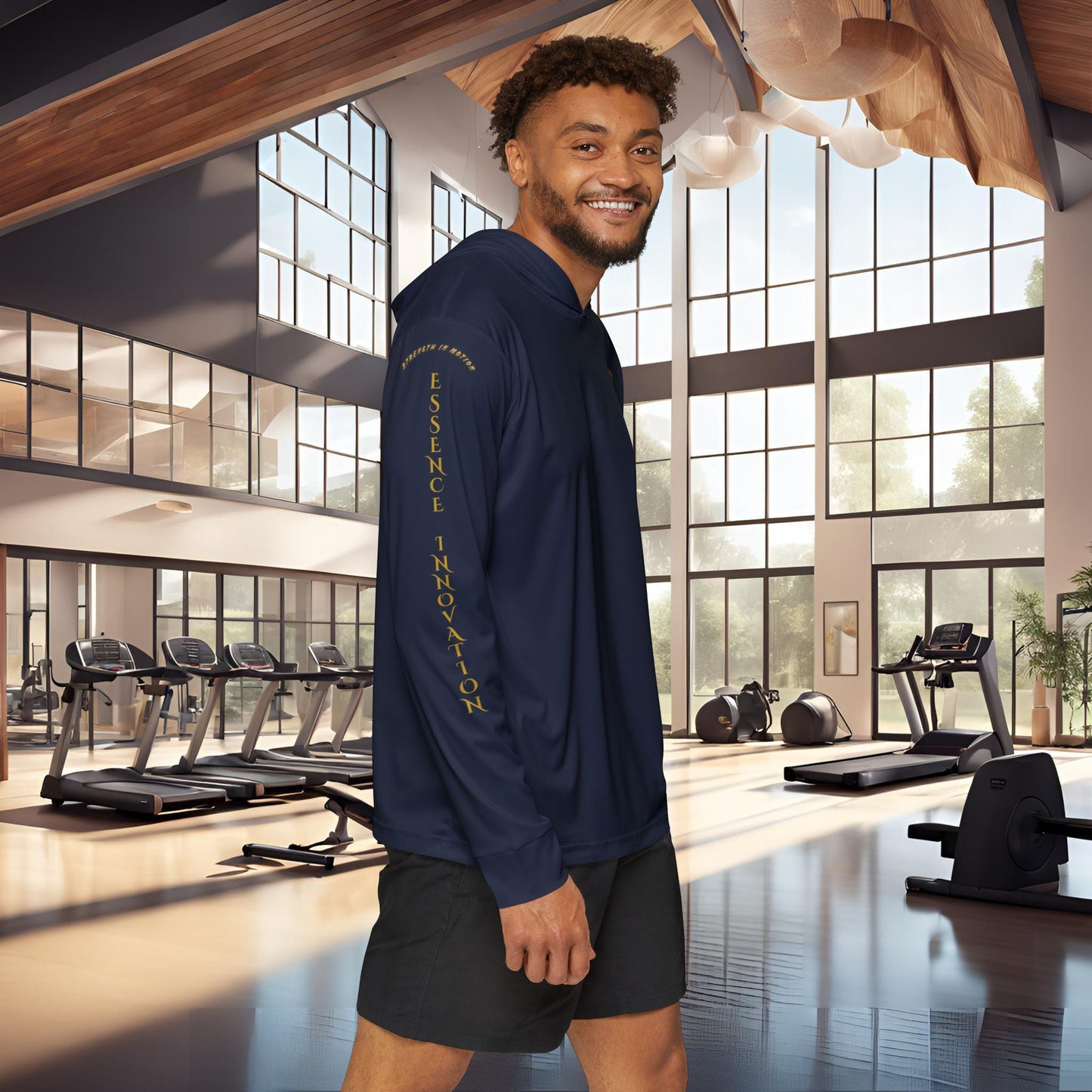 Man wearing a navy Essence Innovation Seek More hoodie with text in a modern gym setting