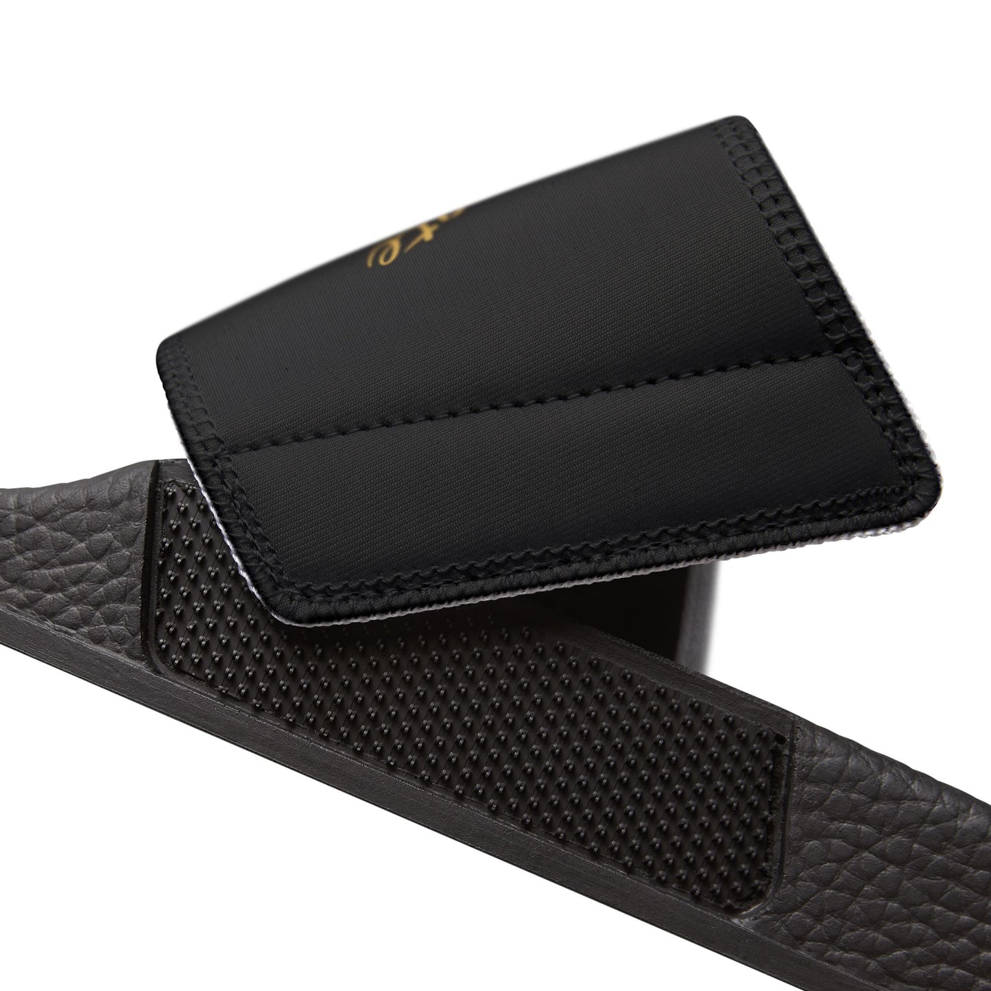 Black EssenceInnoCreate sandal with textured strap on a white background
