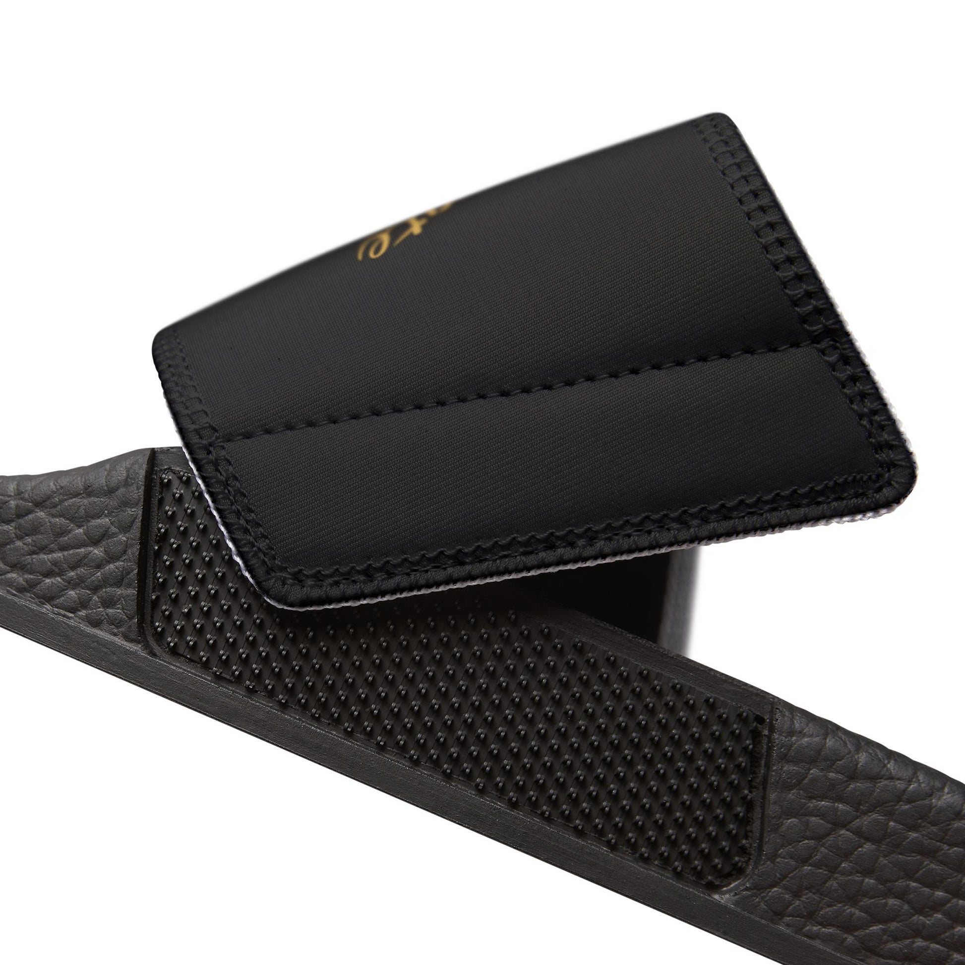 Black EssenceInnoCreate sandal with textured strap on a white background