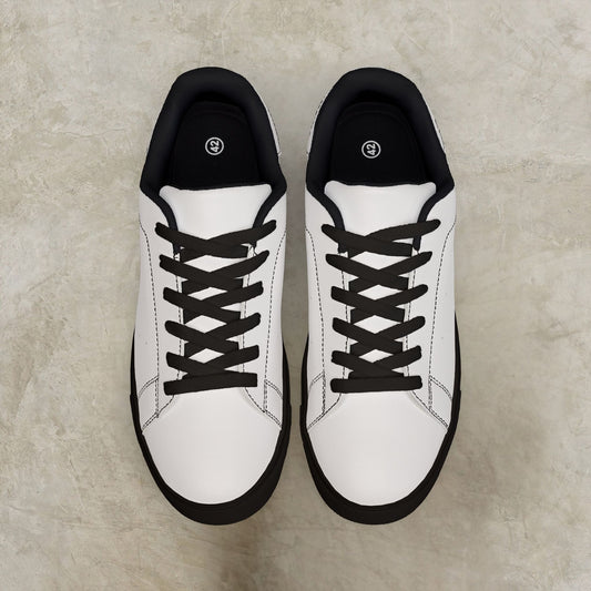 White EssenceInnoCreate sneakers with black soles on a beige surface