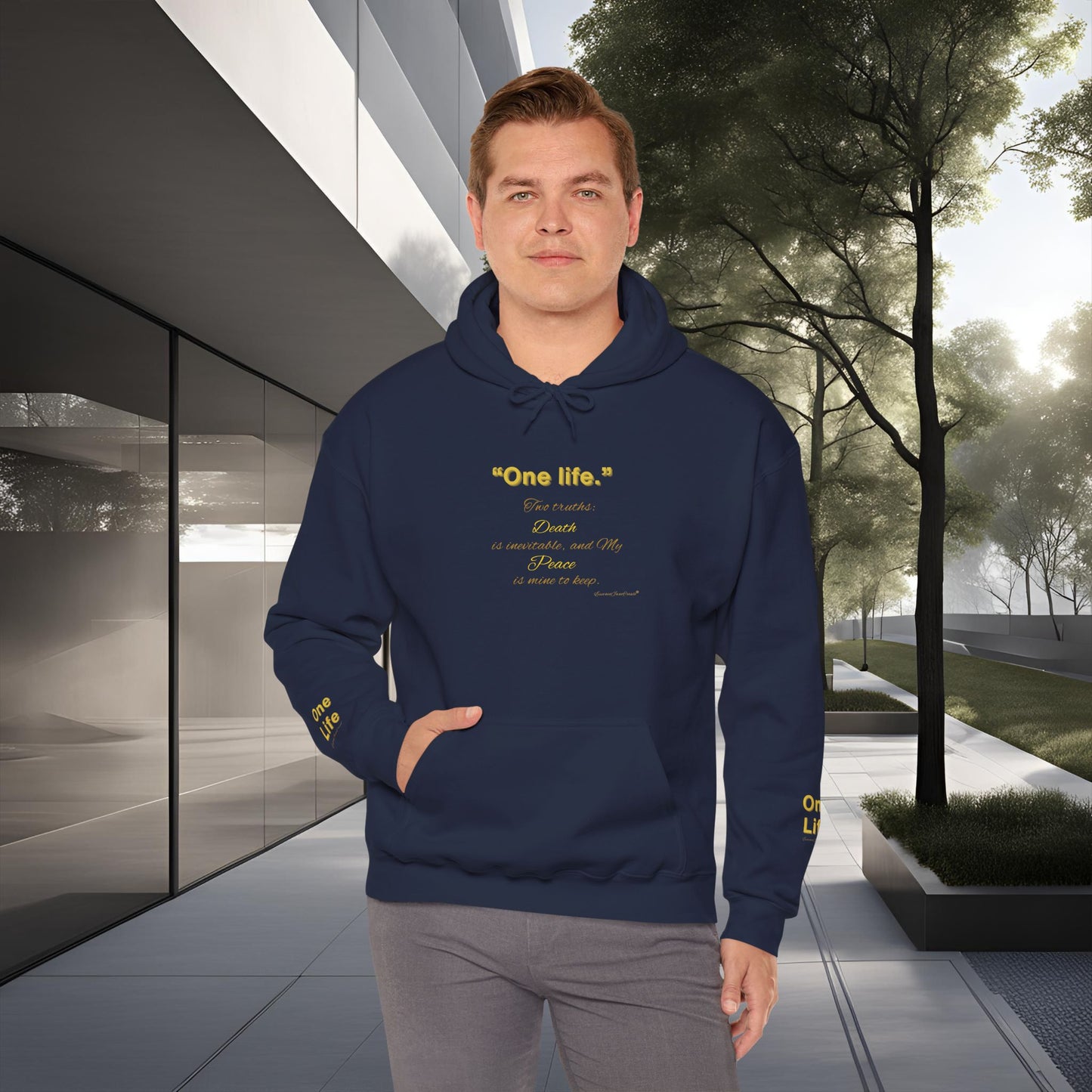 Man wearing a navy blue Essence Innovation 'One Life' hoodie with text in an urban setting