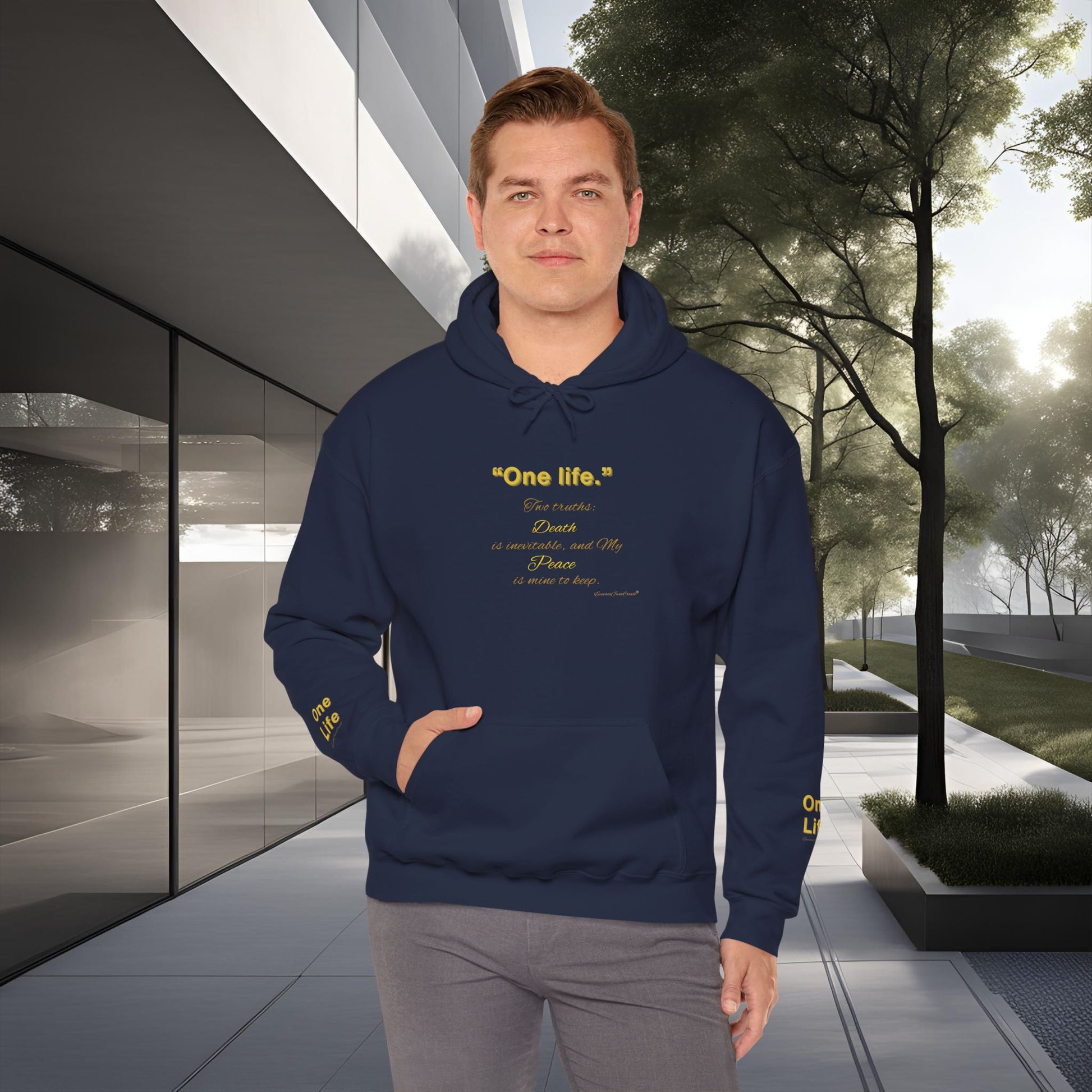 Man wearing a navy blue Essence Innovation 'One Life' hoodie with text in an urban setting