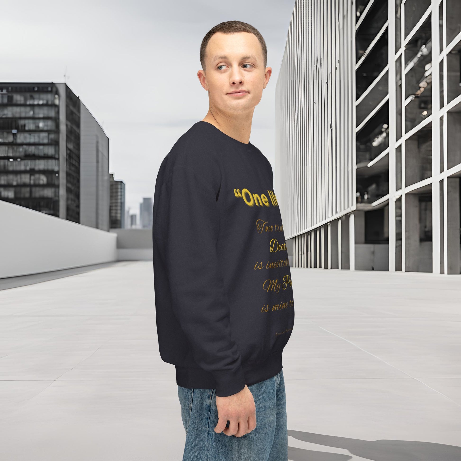 Man wearing a black sweatshirt with yellow text in an urban setting