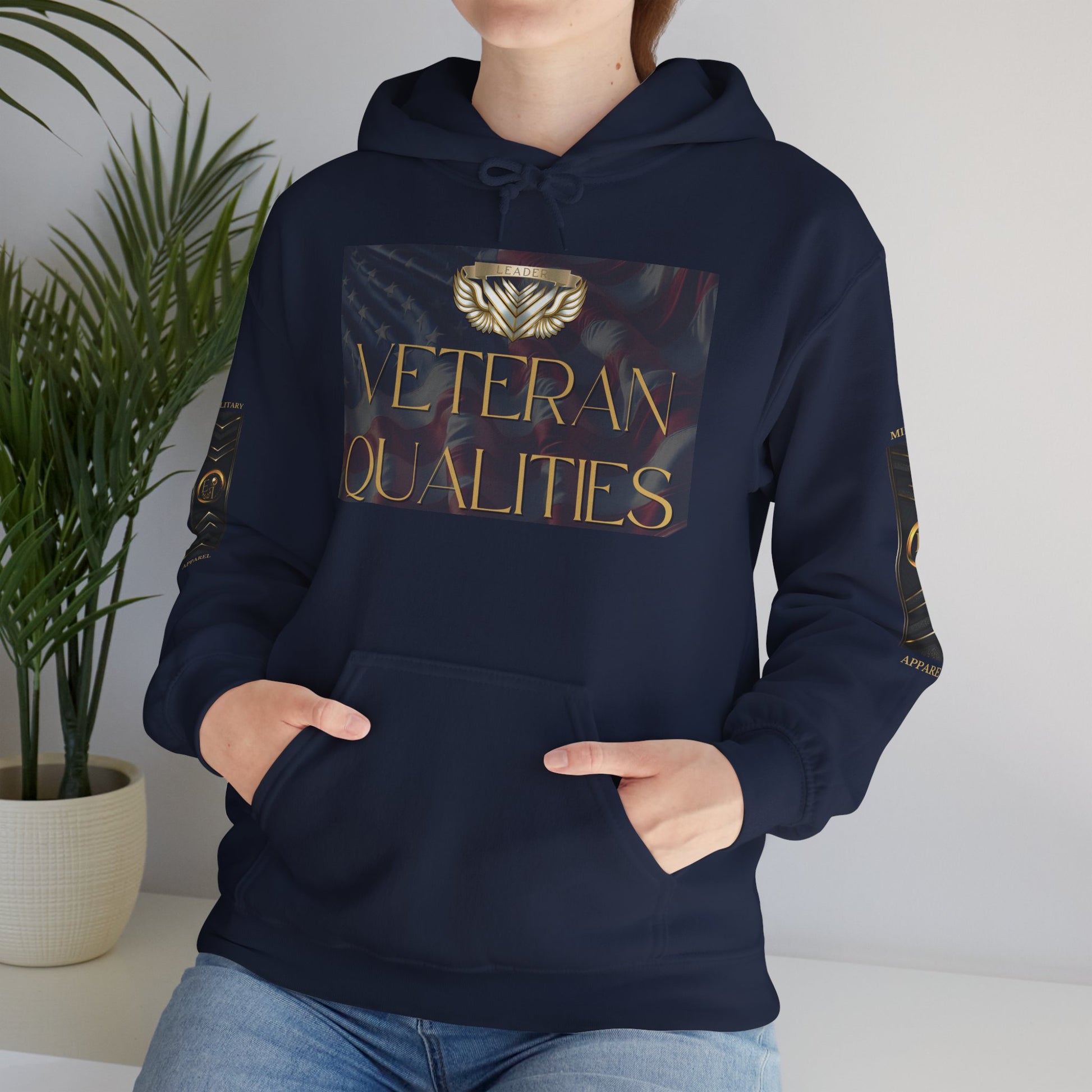 Person wearing a black Essence Innovation hoodie with 'Veteran Qualities' design, standing against a neutral background.