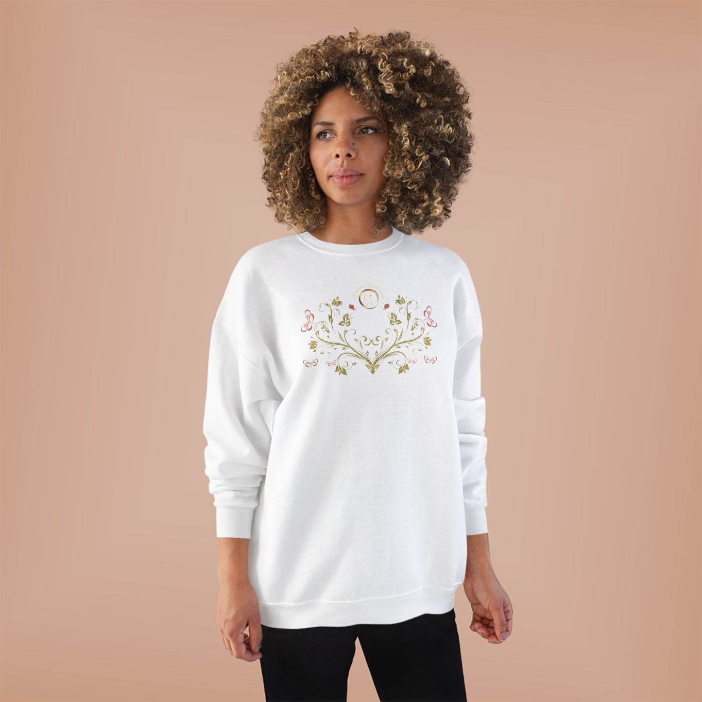 Woman wearing a white sweatshirt with floral Essence Innovation Bohemian Butterfly Crest design on a beige background