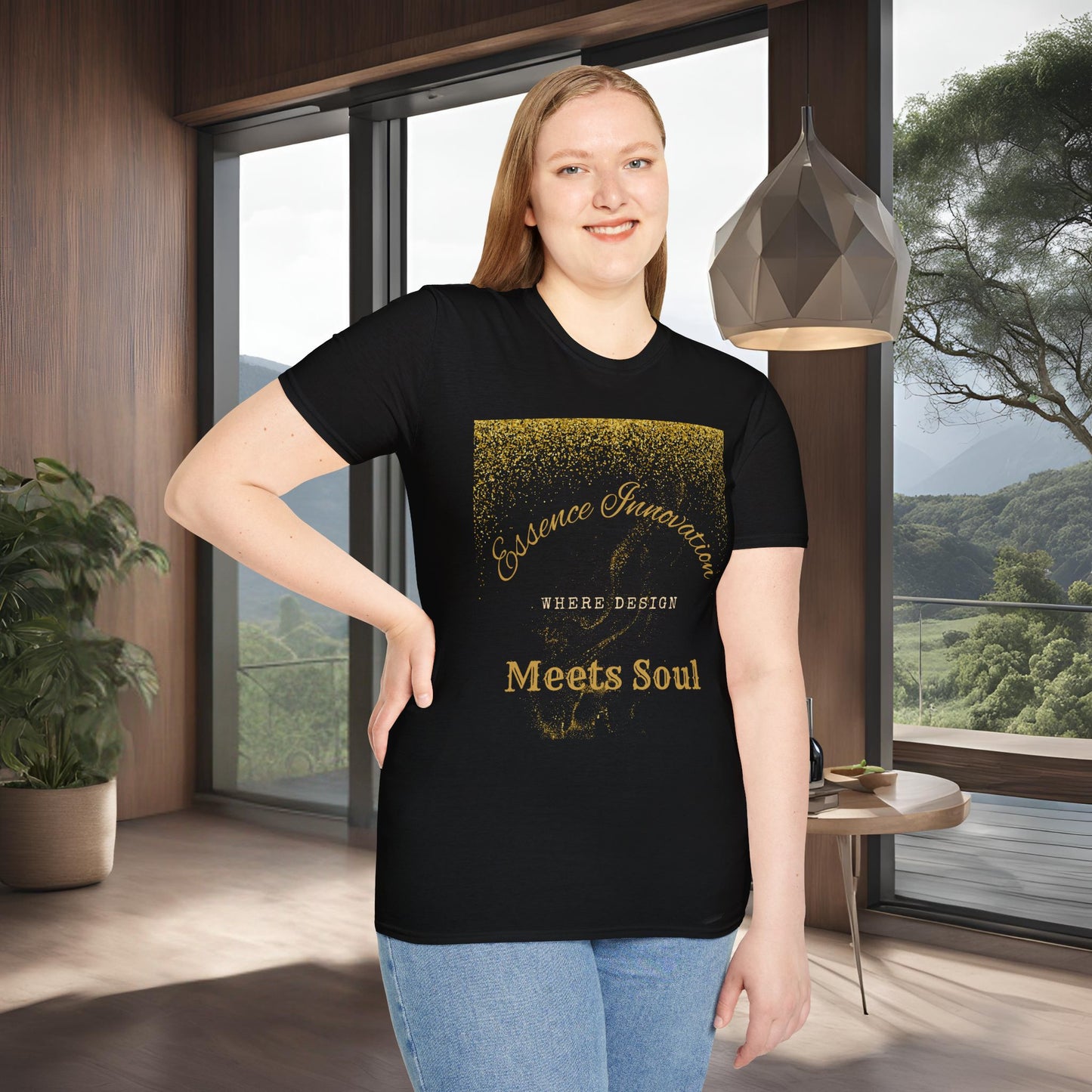 Person wearing a black t-shirt with gold Essence Innovation 'Design Meets Soul' text in a modern room with large windows.