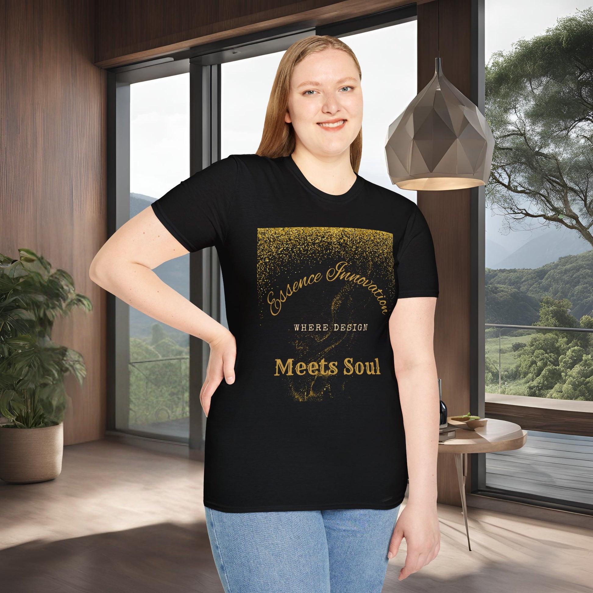 Person wearing a black t-shirt with gold Essence Innovation 'Design Meets Soul' text in a modern room with large windows.