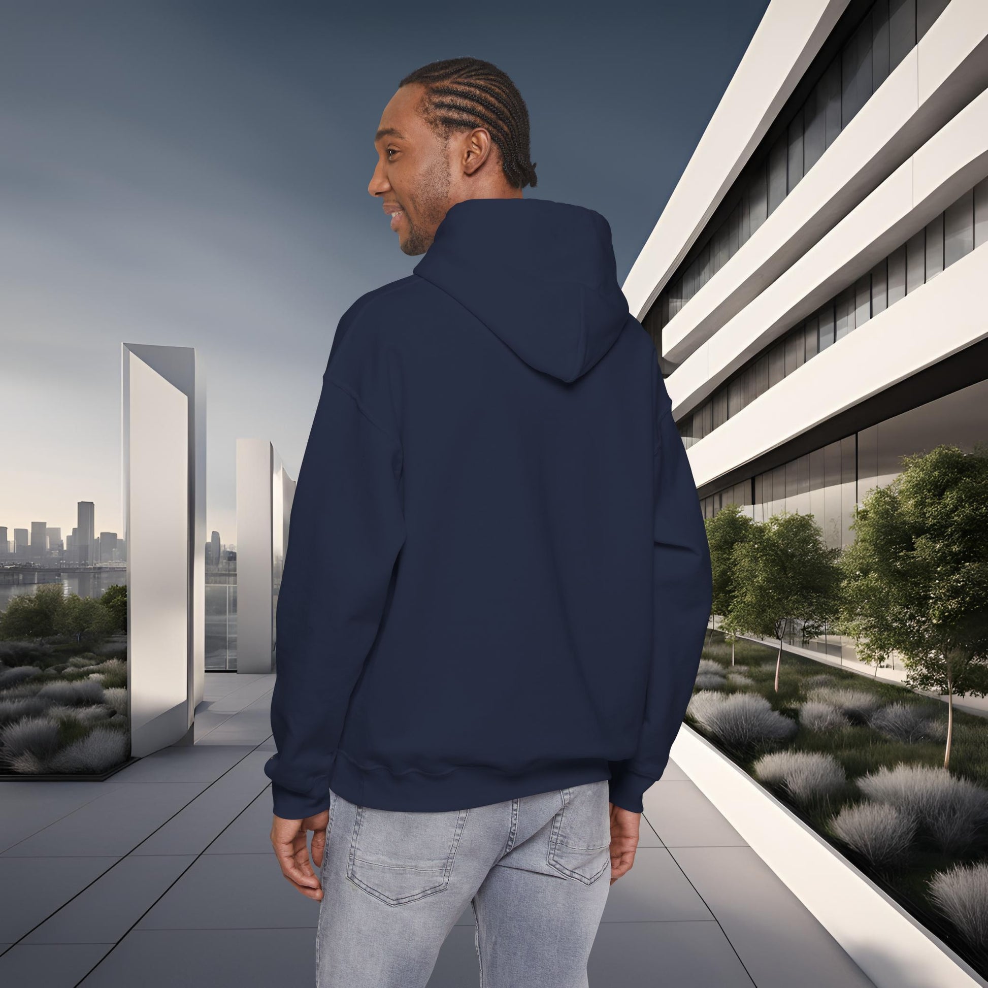 Man wearing a navy blue 'EssenceInnoCreate' hoodie standing on a modern rooftop with cityscape in the background