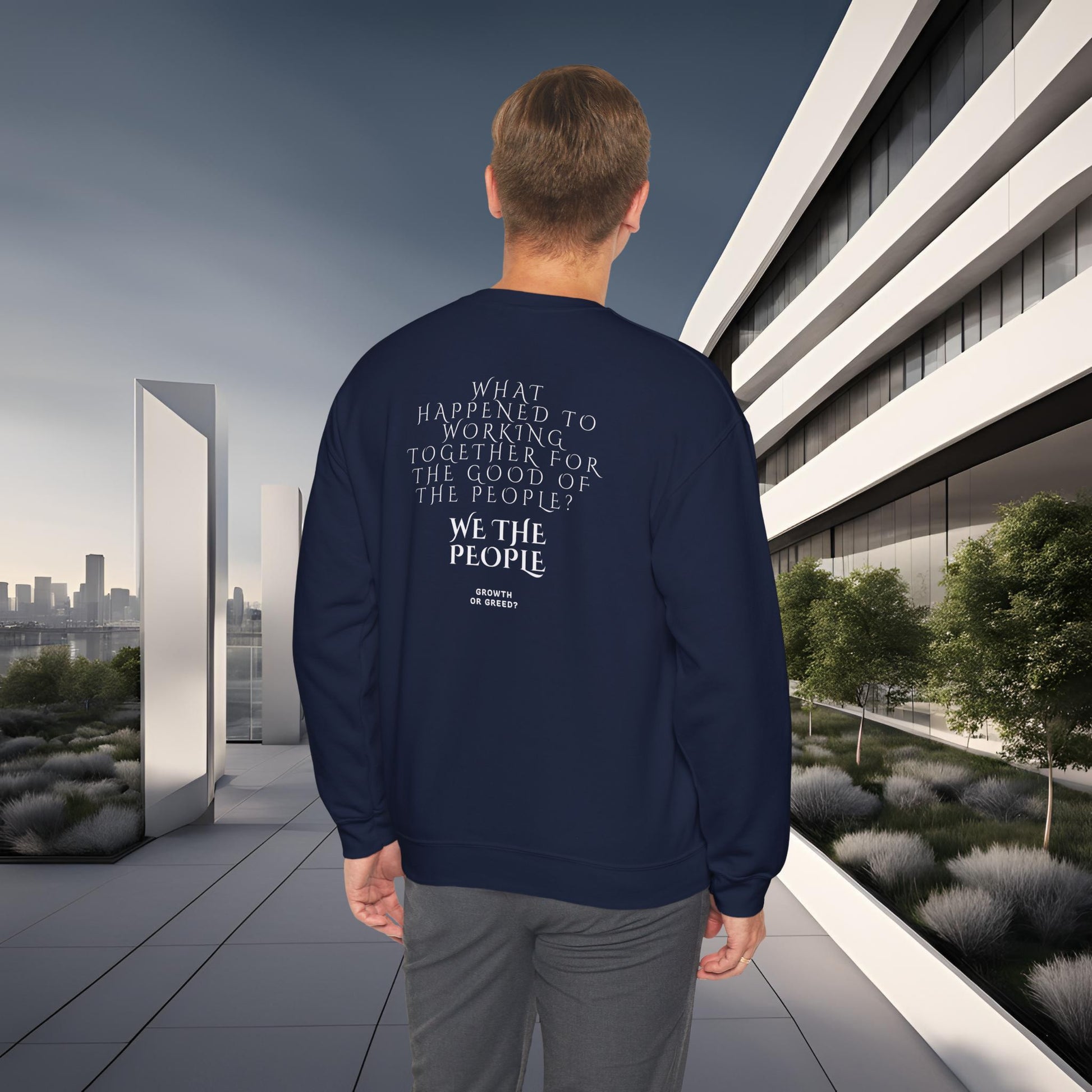 Person wearing a navy blue EssenceInnoCreate Quiet Resolve sweatshirt with text in an urban setting