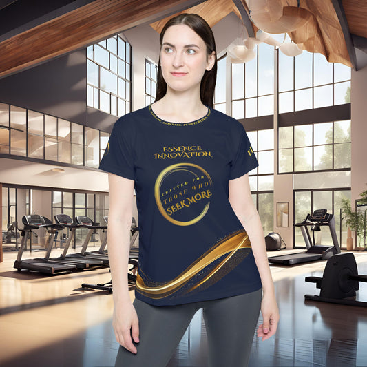 Woman wearing a blue t-shirt with gold Essence Innovation Seek More text in a gym setting