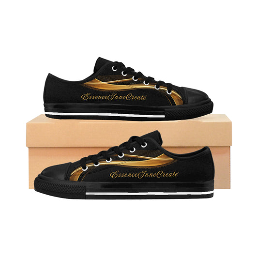 Black 'EssenceInnoCreate' sneakers with gold accents on a wooden box against a white background