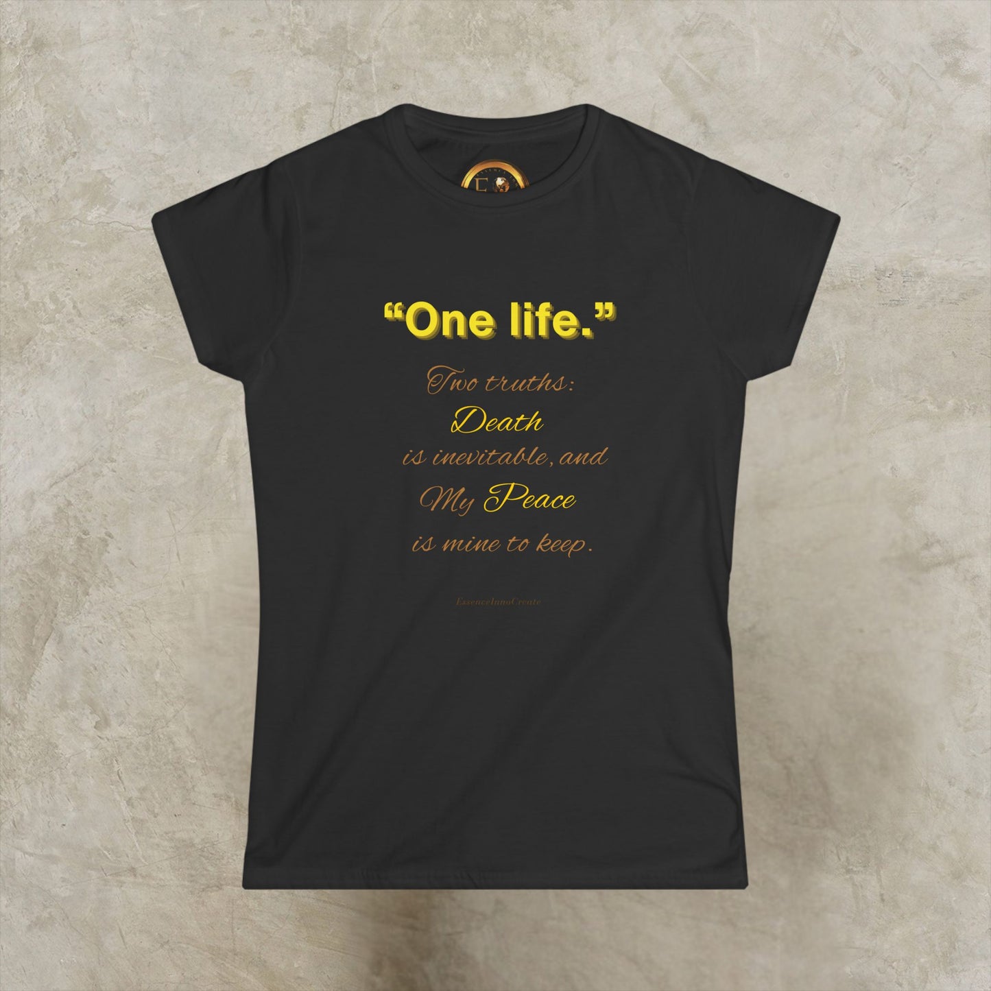 Black t-shirt with decorative One Life design on a beige background