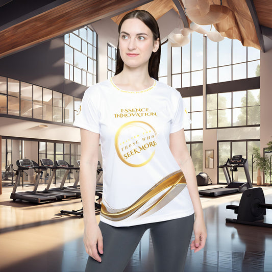 Woman wearing a white t-shirt with gold Essence Innovation Seek More text in a gym setting