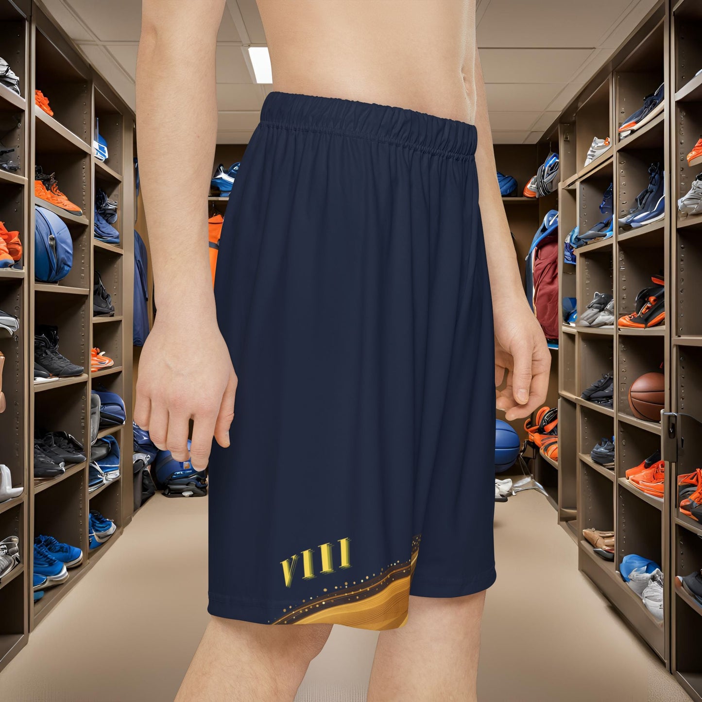 Person wearing navy shorts with a yellow design in a locker room.