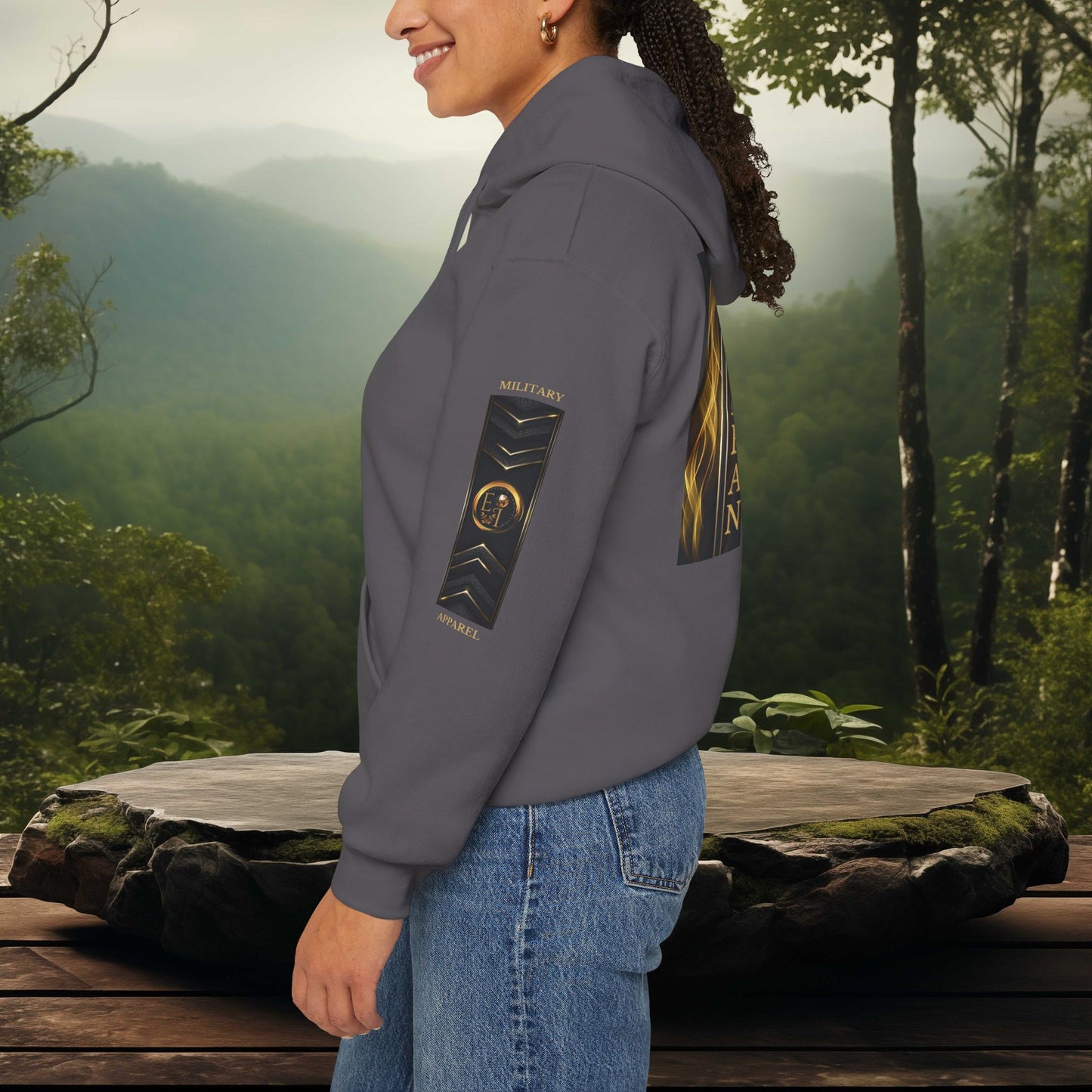 Person wearing a gray Essence Innovation military apparel hoodie with a mountainous landscape in the background