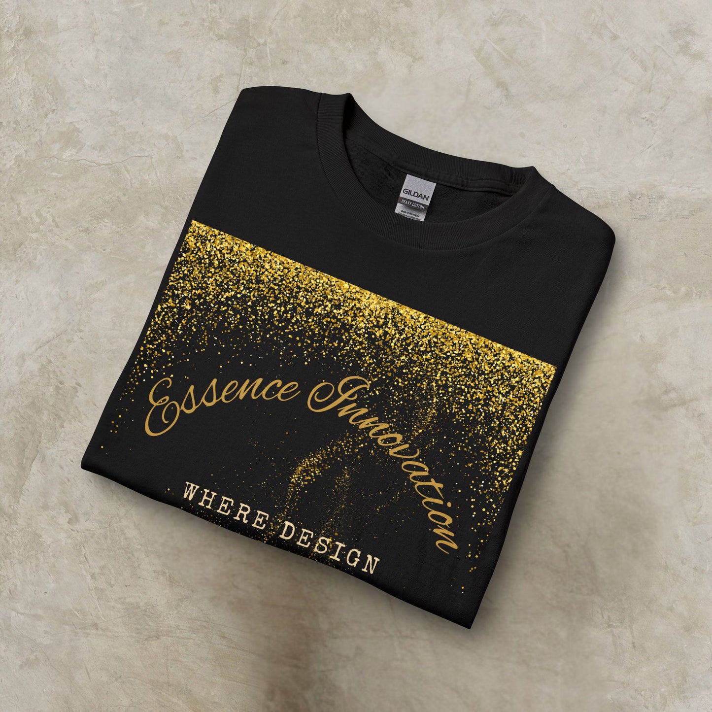 Folded black t-shirt with gold Essence Innovation 'Design Meets Soul' text on a beige surface
