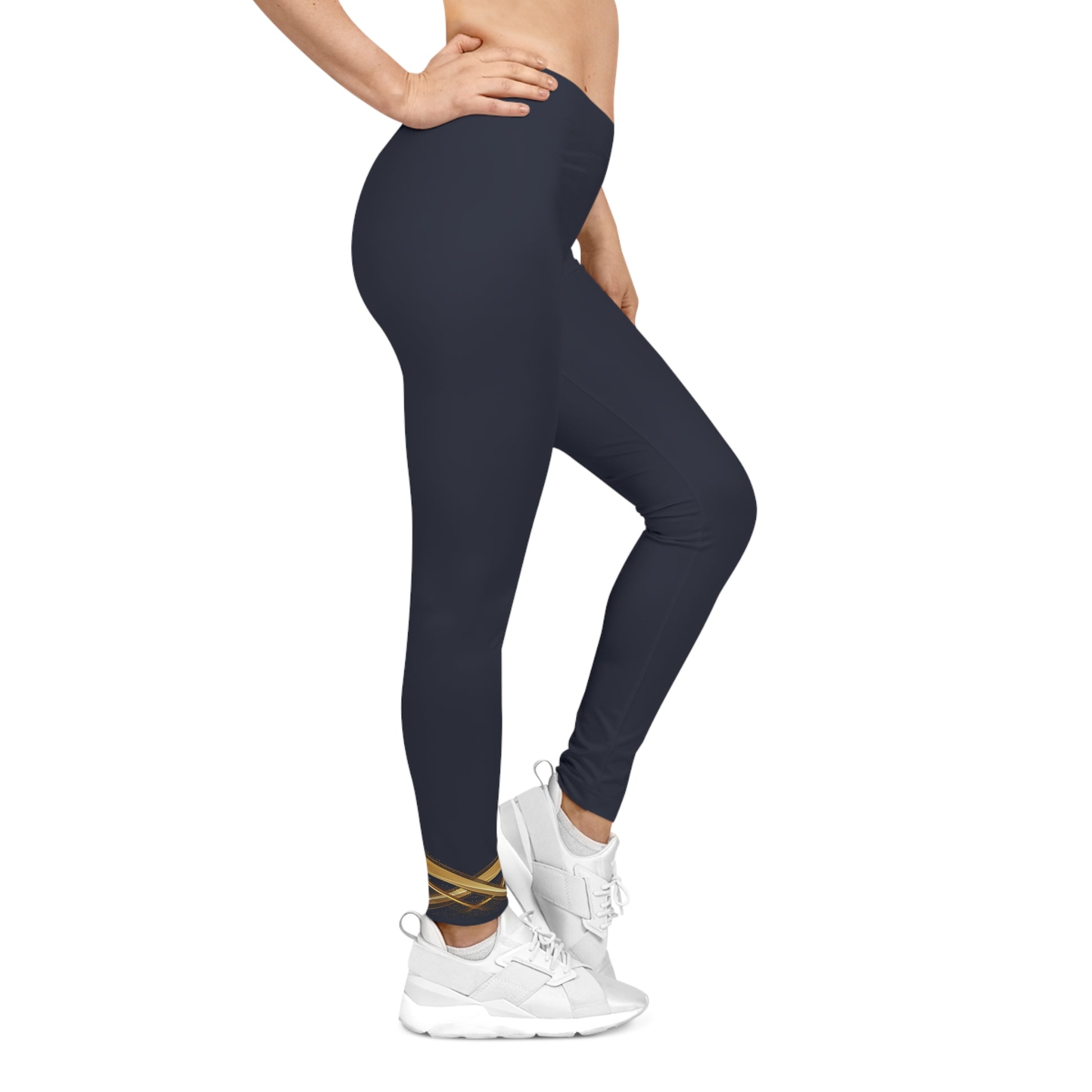 Person wearing navy leggings and white sneakers on a white background