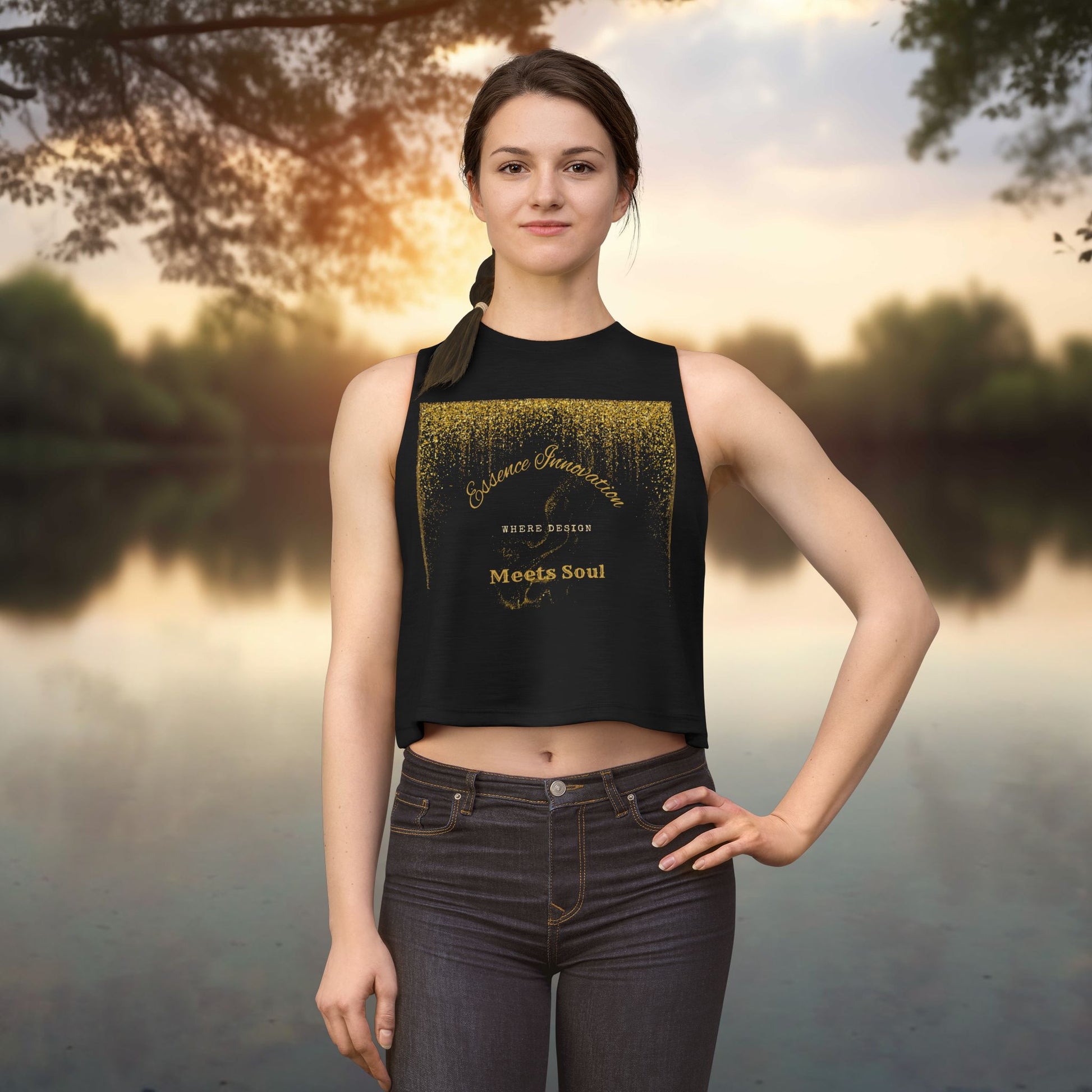 Woman wearing a black sleeveless top with gold Essence Innovation 'Design Meets Soul' text against a natural background