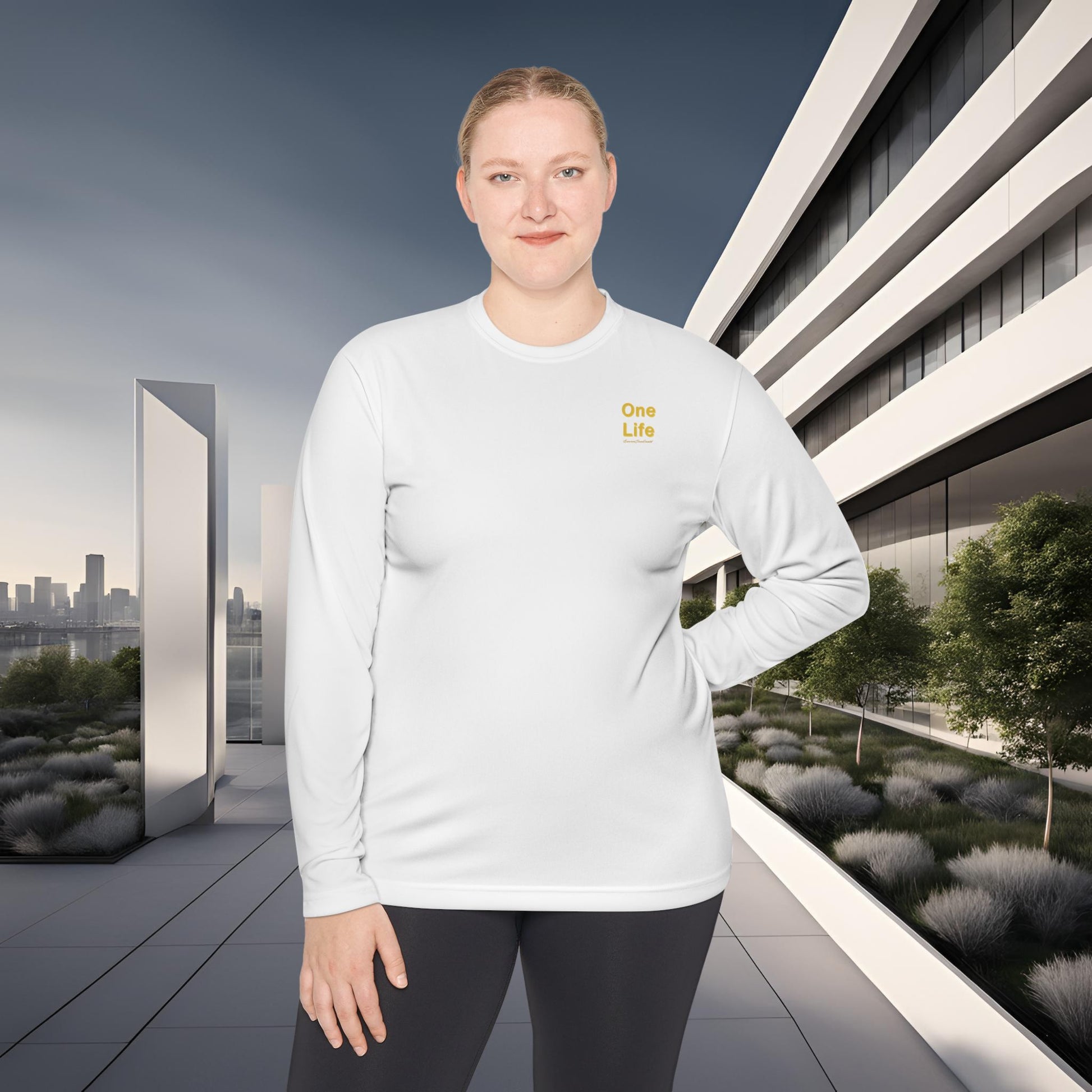 Woman wearing a white long-sleeve shirt with a One Life logo in an urban setting