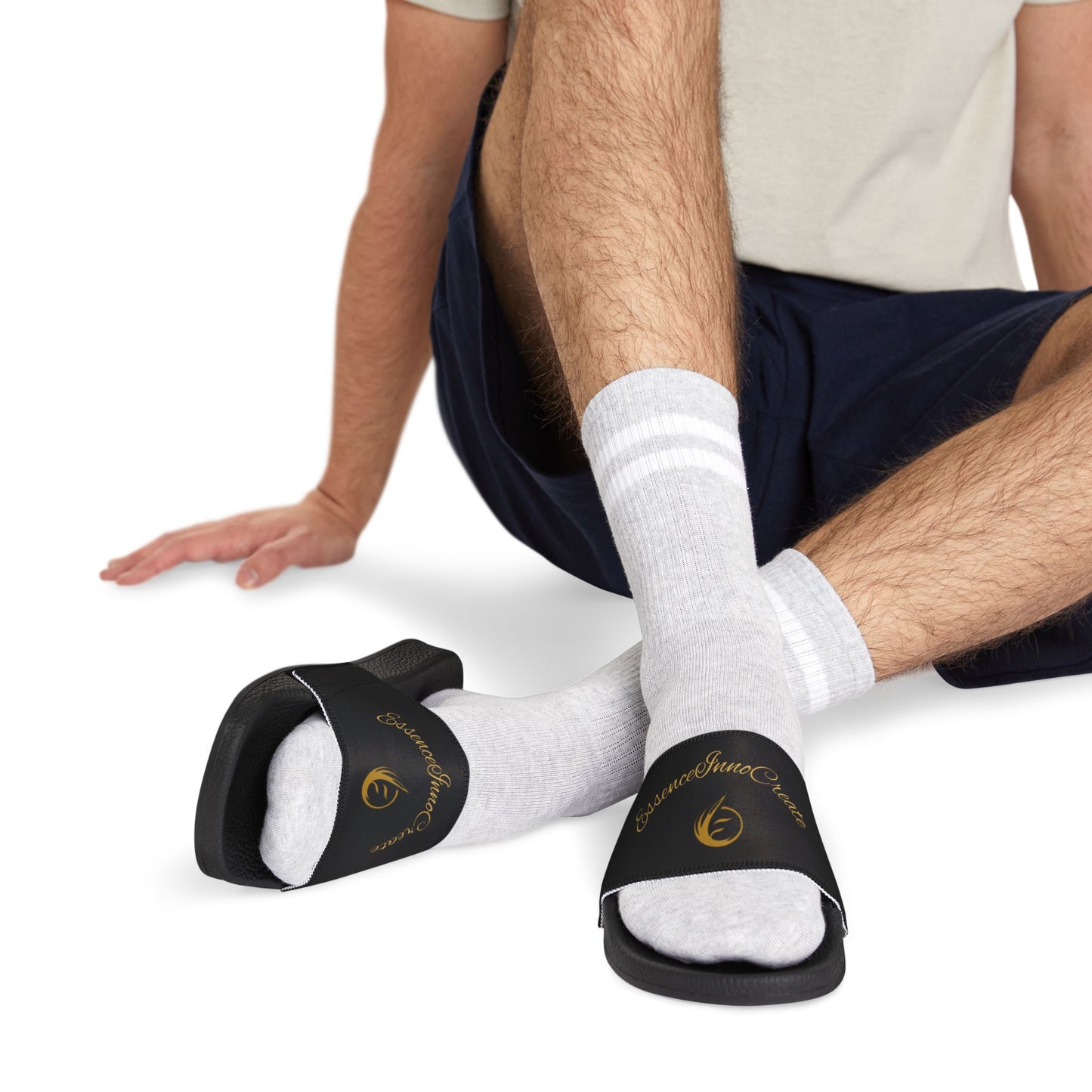 Person wearing black EssenceInnoCreate slides with white socks on a white background