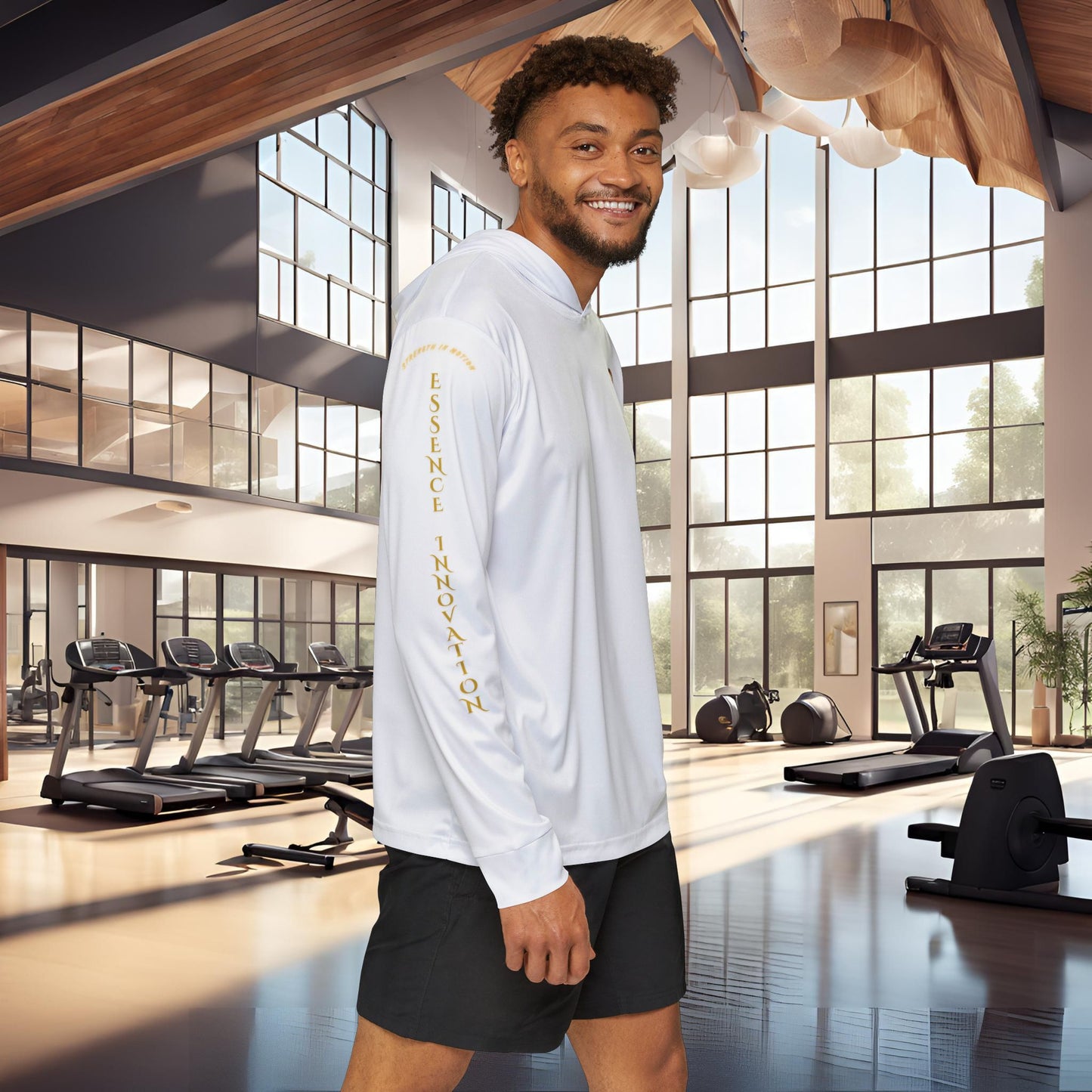 Man wearing a white Essence Innovation Seek More long-sleeve shirt with text in a gym setting
