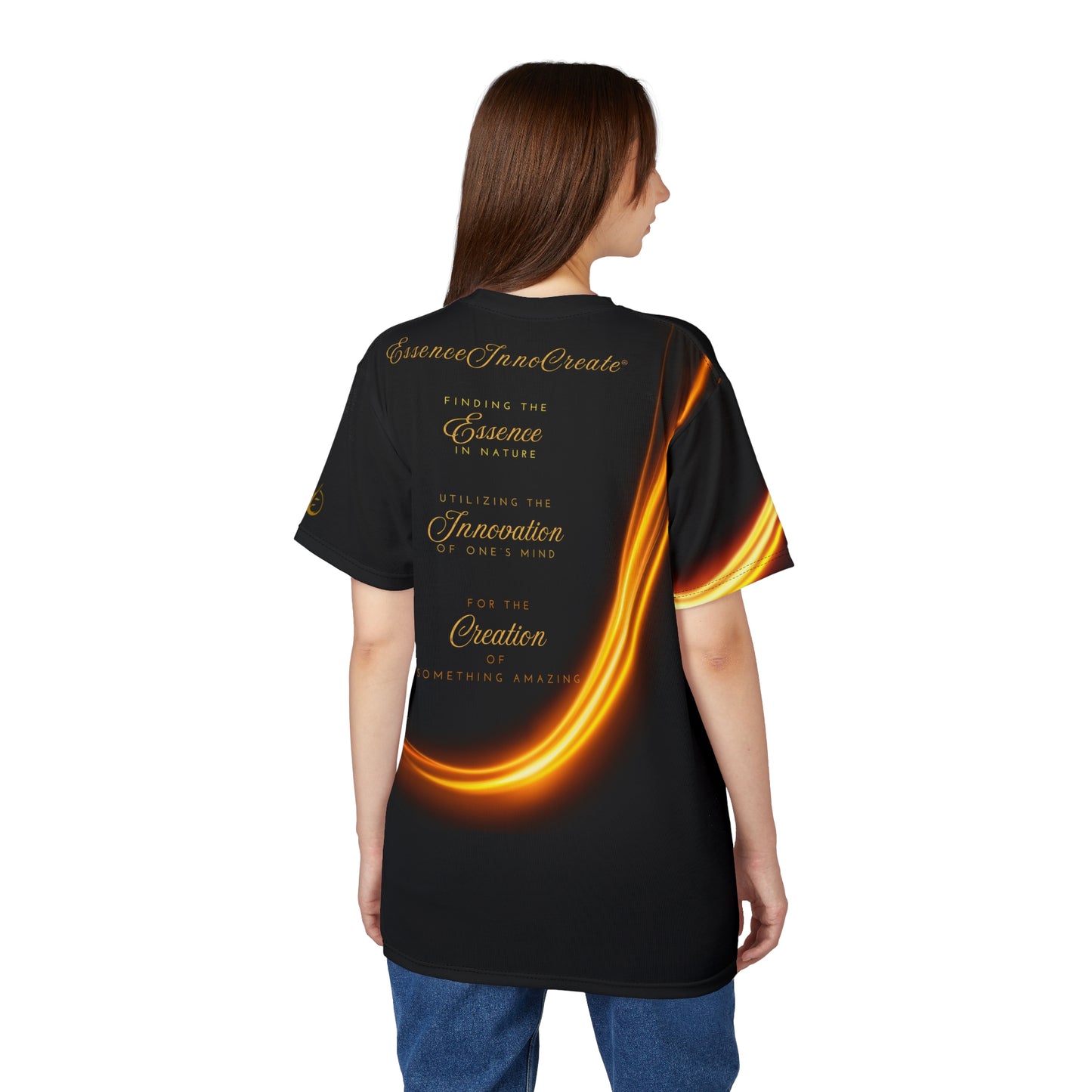 Person wearing a black 'EssenceInnoCreate' t-shirt with gold and orange design on the back