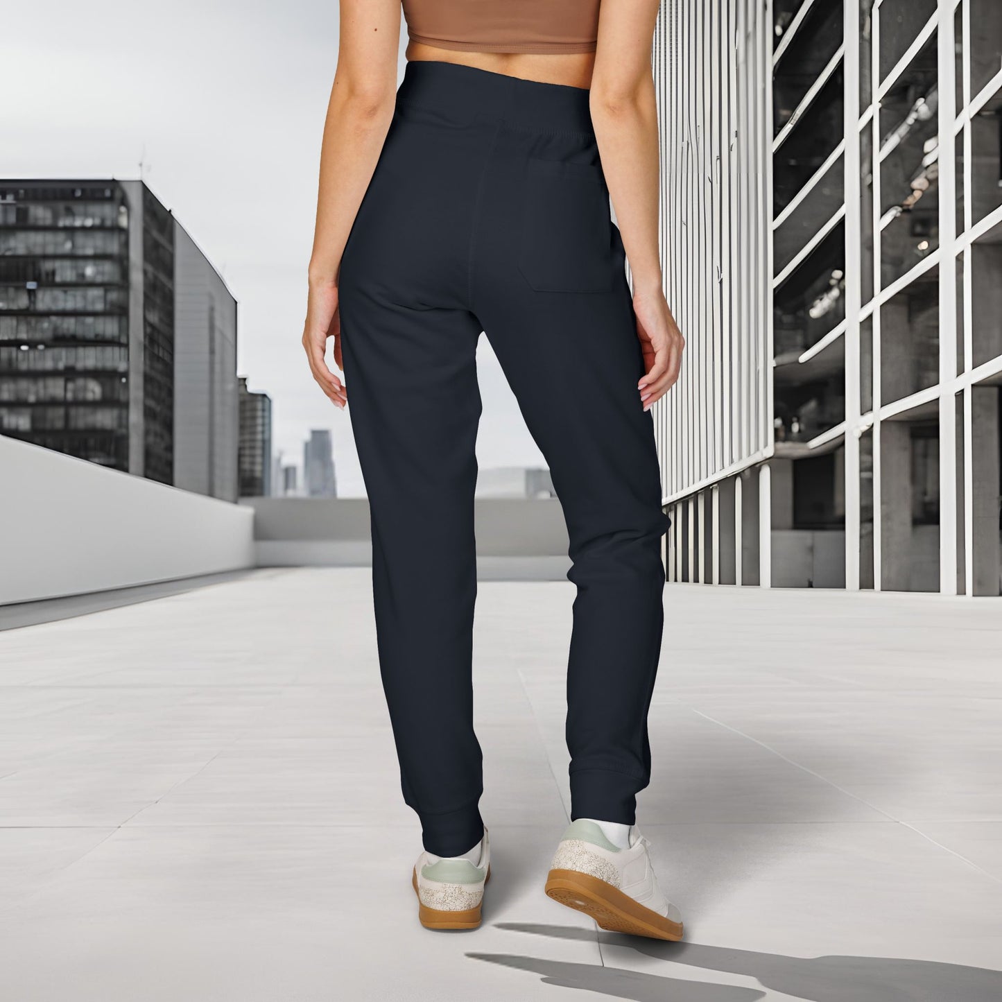 Person wearing navy 'EssenceInnoCreate' Quiet Resolve pants and white sneakers in an urban setting