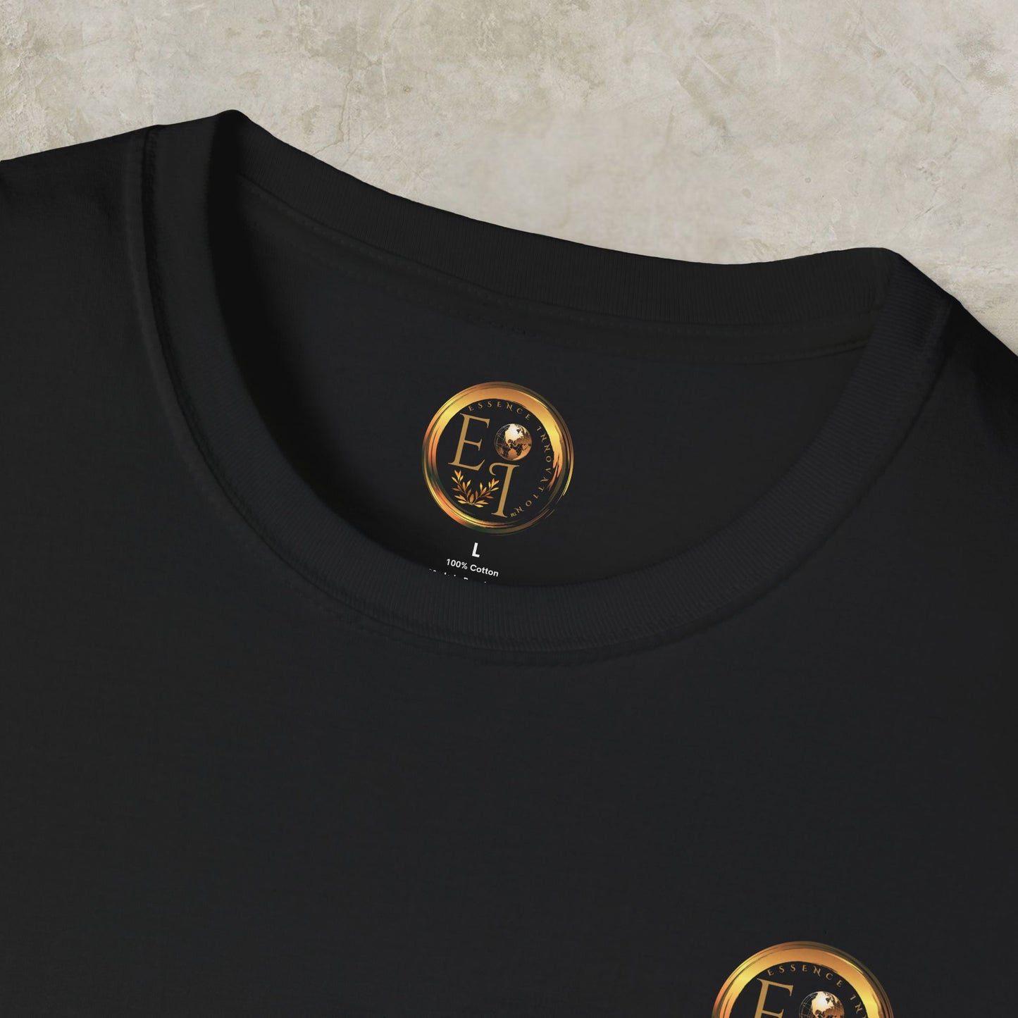 Black t-shirt with a gold Essence Innovation logo on a textured surface