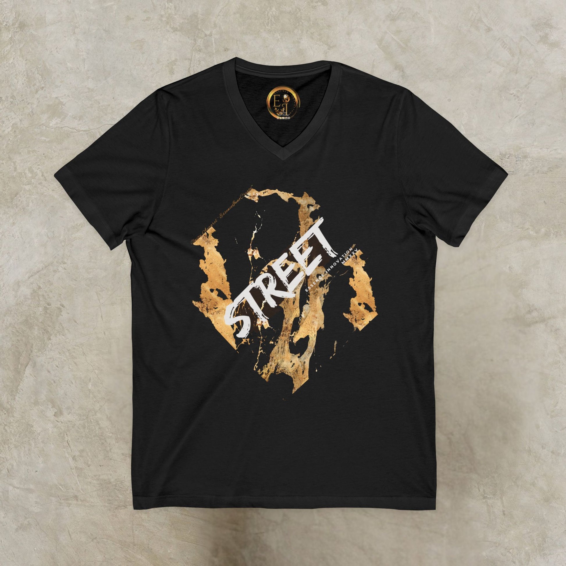 Black EssenceInnoCreate t-shirt with gold and white graphic design on a textured beige background