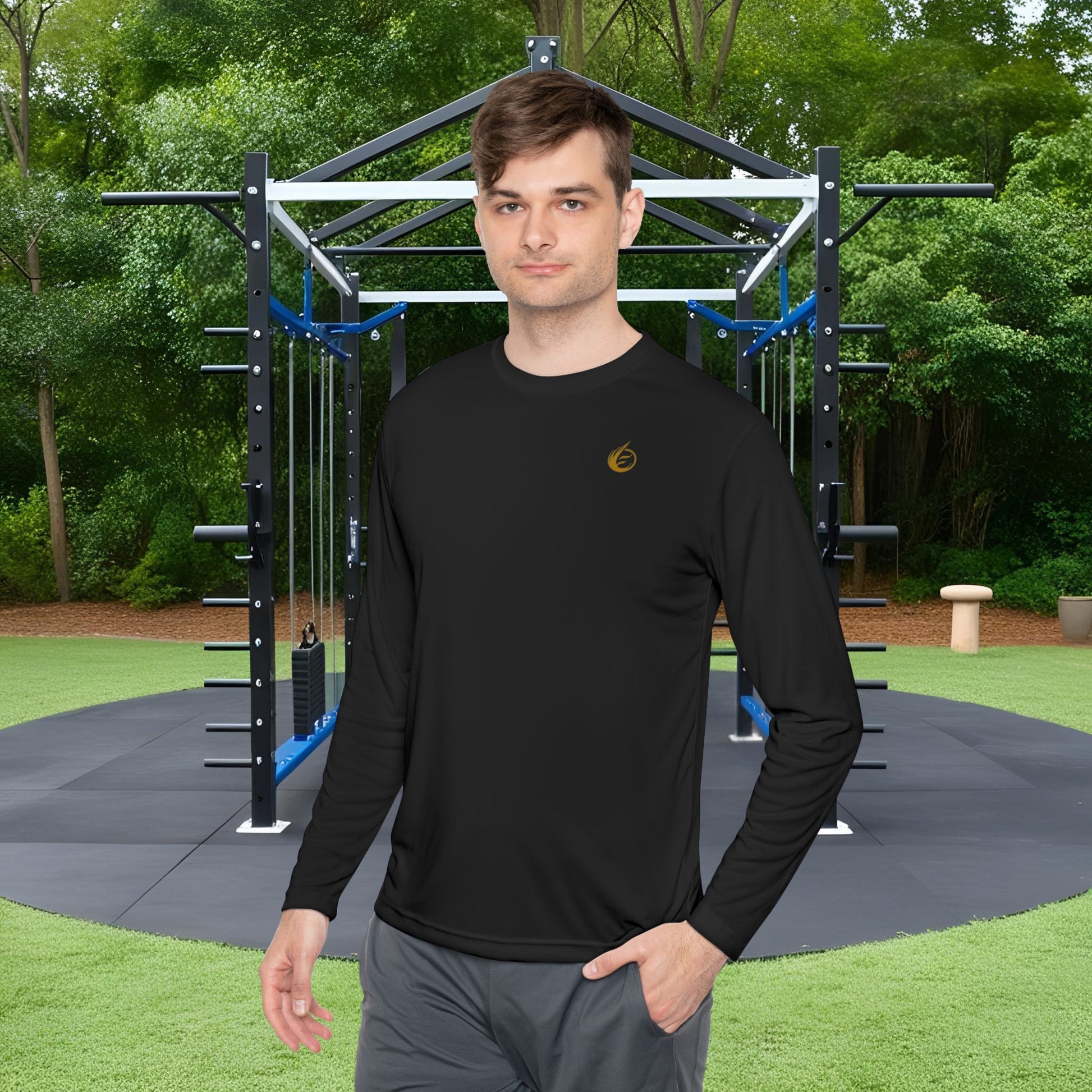 Man wearing a black long-sleeve shirt with 'EssenceInnoCreate' logo in an outdoor fitness area.