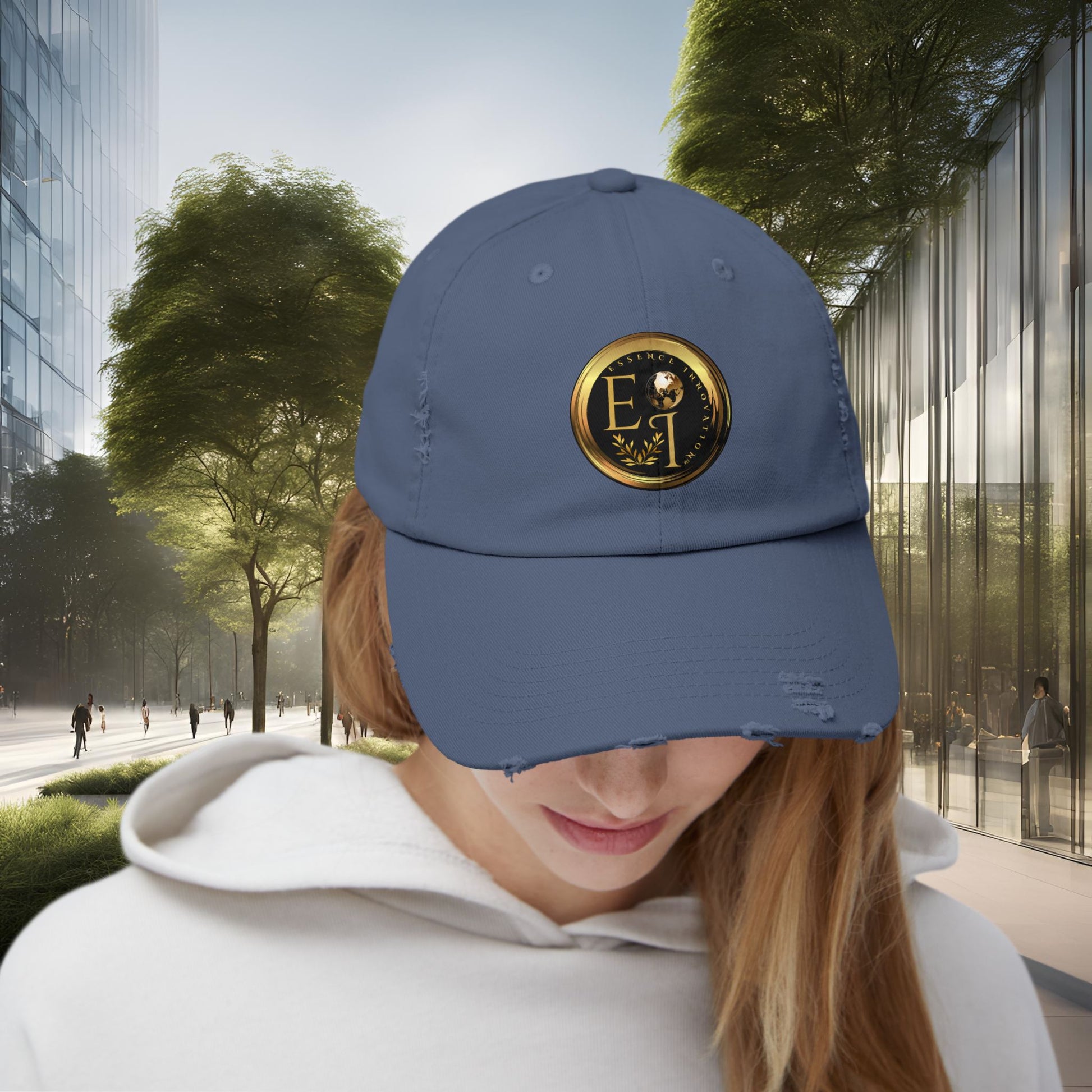 Person wearing a blue Essence Innovation cap with a logo in an urban setting