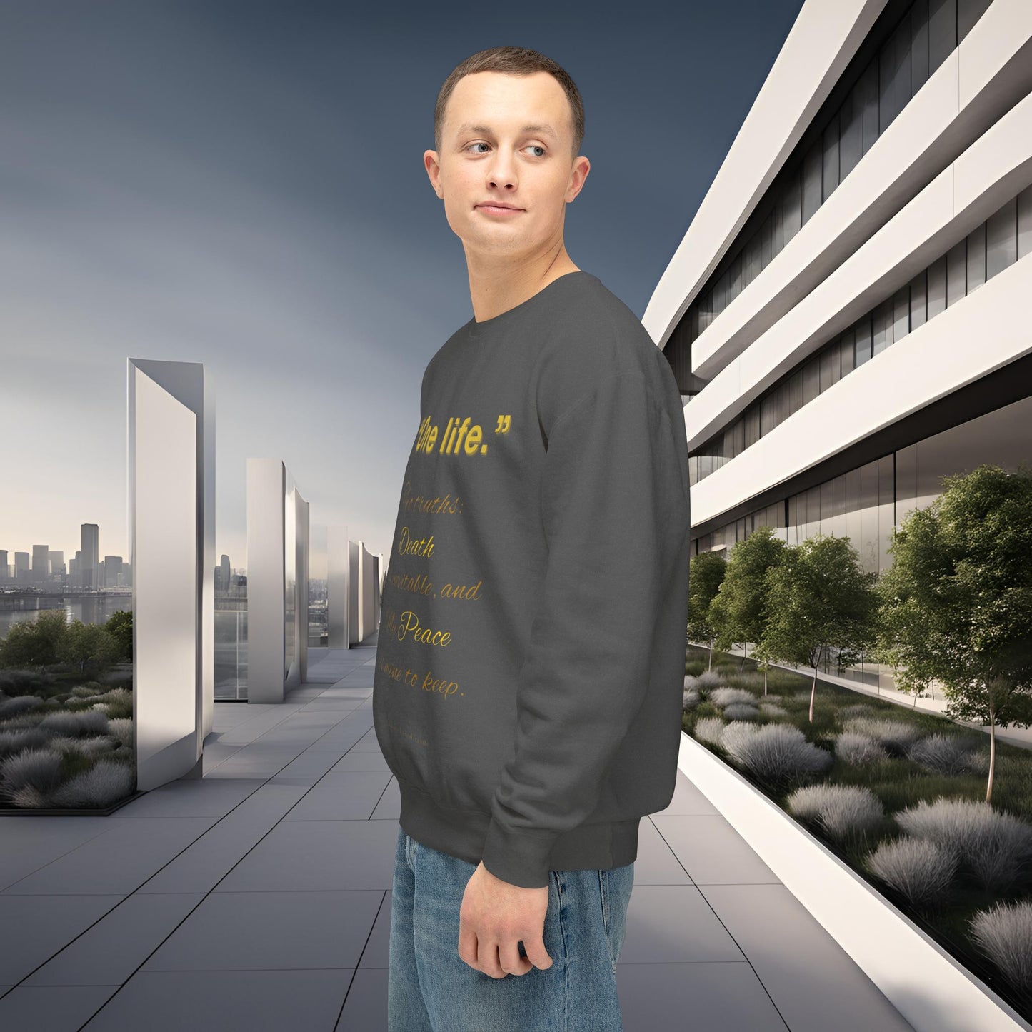 Man wearing a dark gray sweatshirt with text in an urban setting