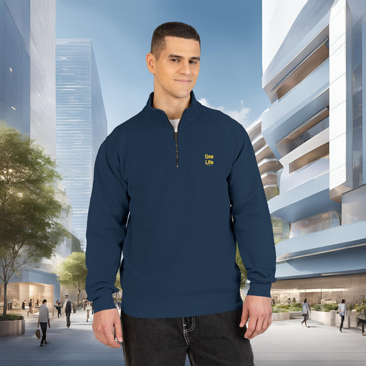 Man wearing a navy blue pullover with a One Life logo in an urban setting