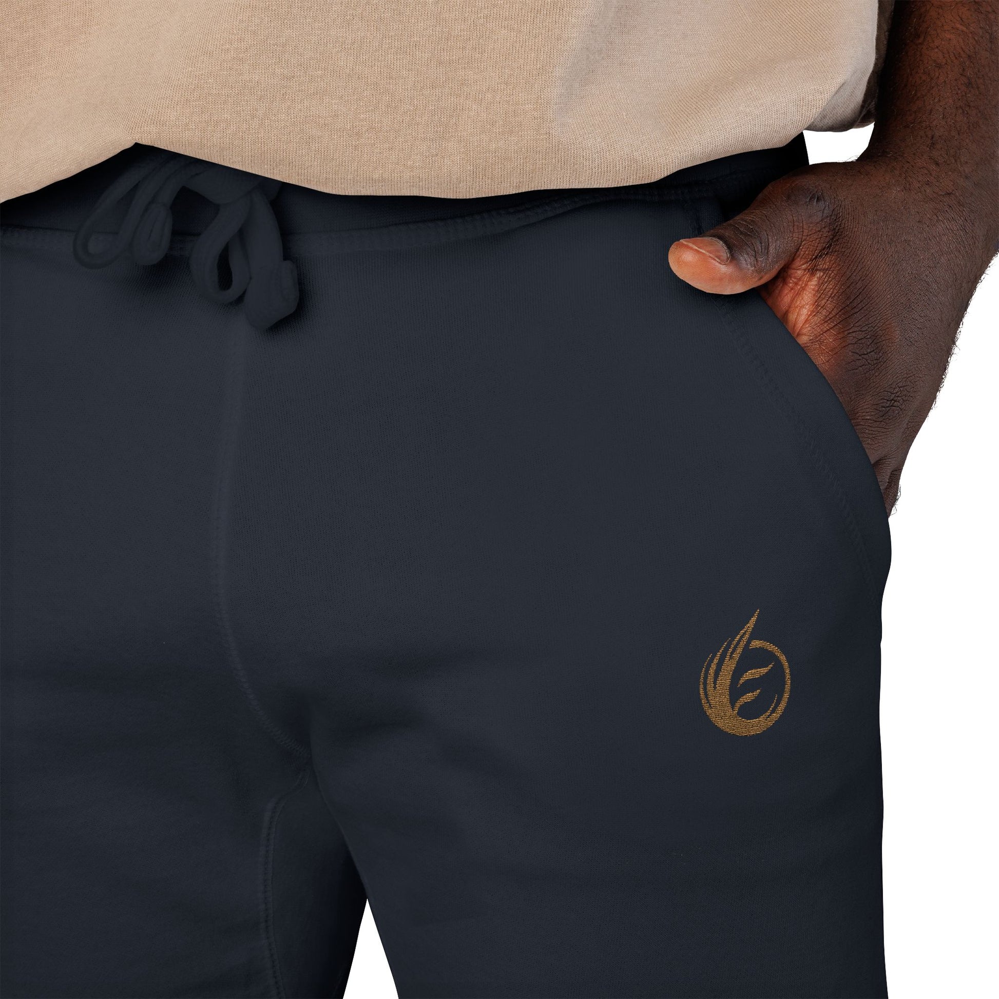 Navy 'EssenceInnoCreate' Quiet Resolve pants with a gold logo on the leg, worn by a person.