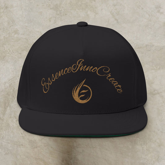 Black cap with gold EssenceInnoCreate text and logo on a beige background
