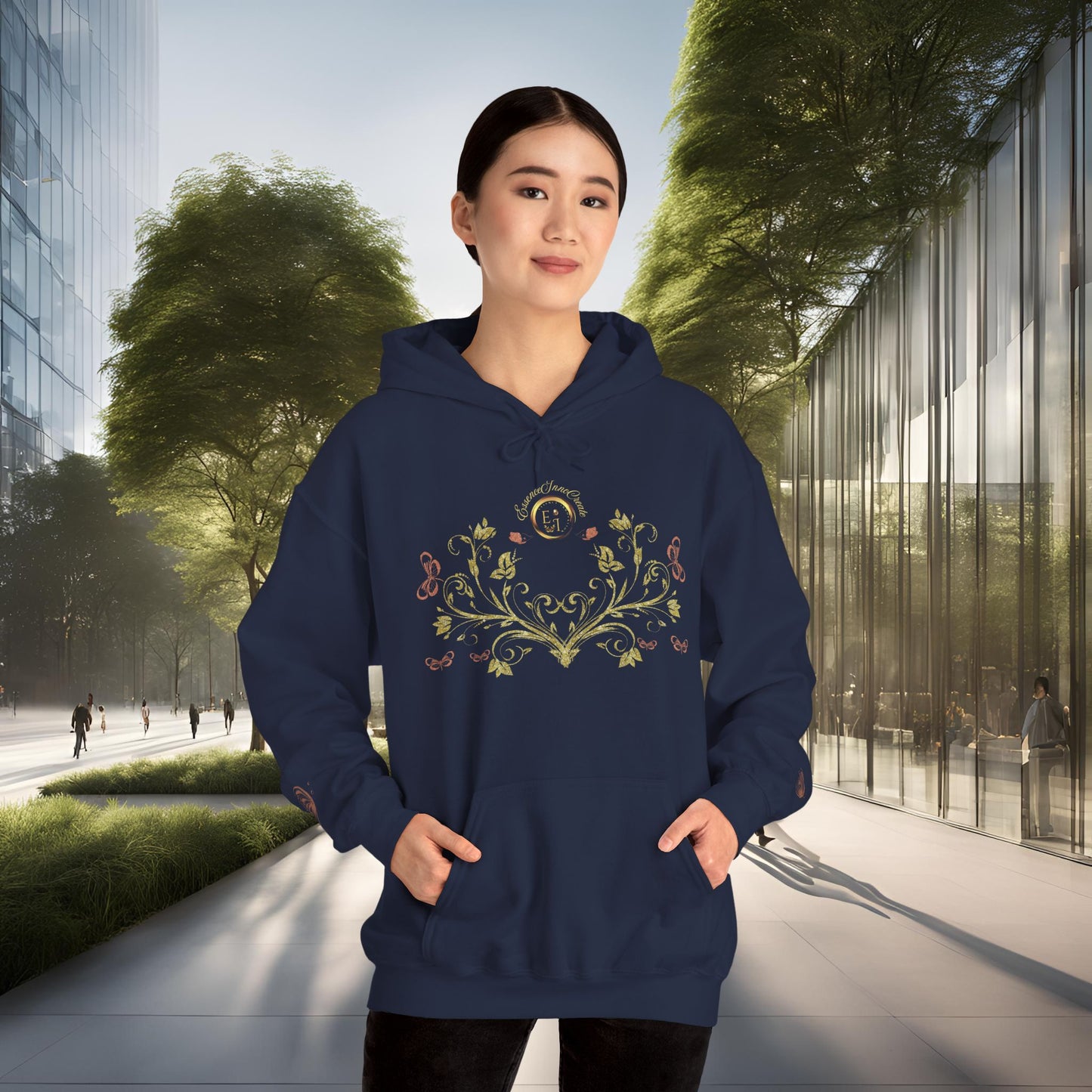 Person wearing a navy blue hoodie with a decorative Essence Innovation Bohemian Butterfly Crest emblem in an urban setting