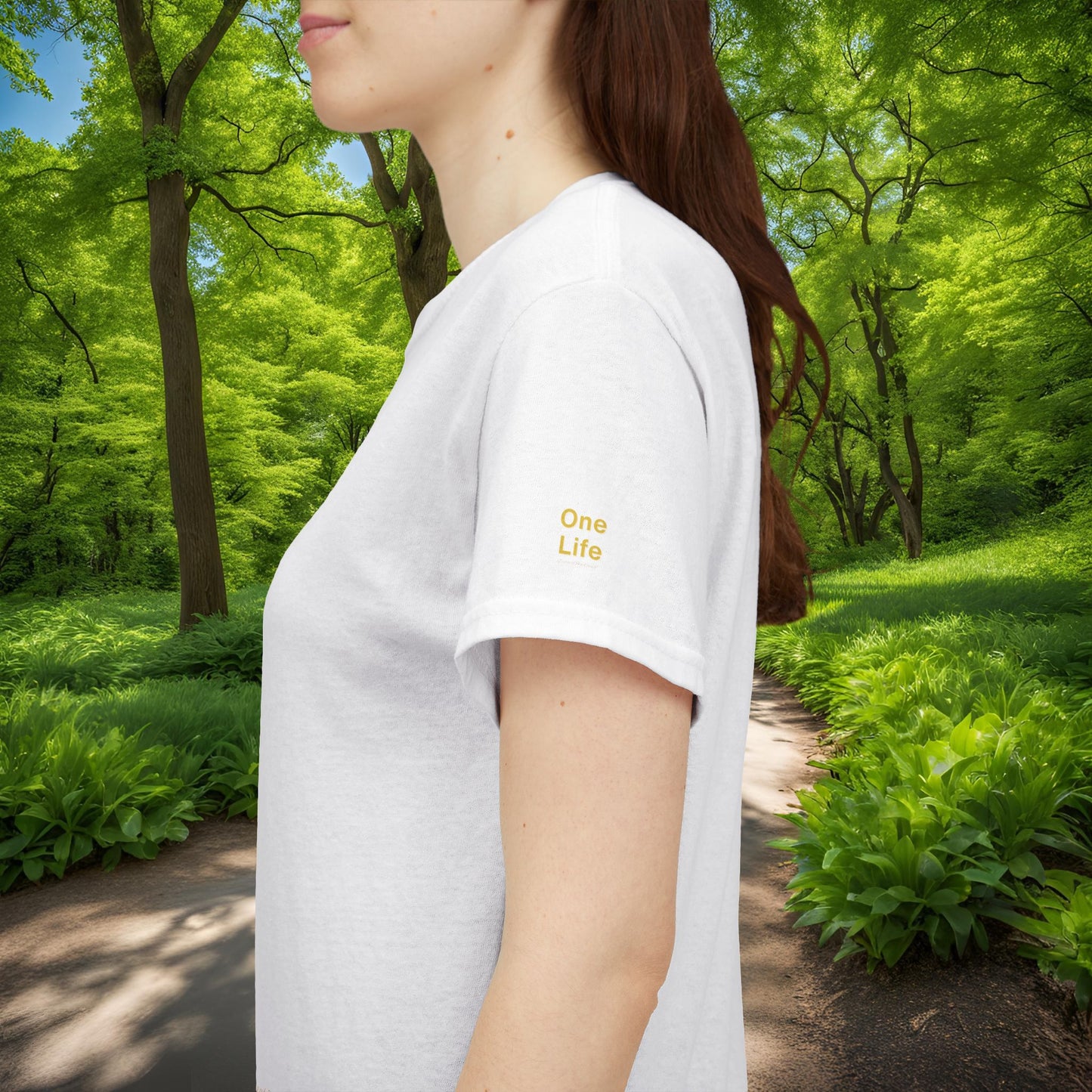 Person wearing a white t-shirt with 'One Life' text in a forest setting