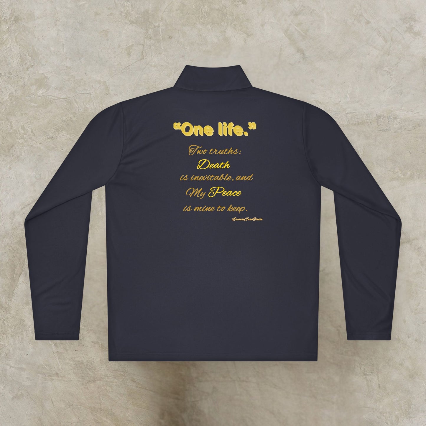 Black long-sleeve shirt with gold One Life logo on a textured beige background