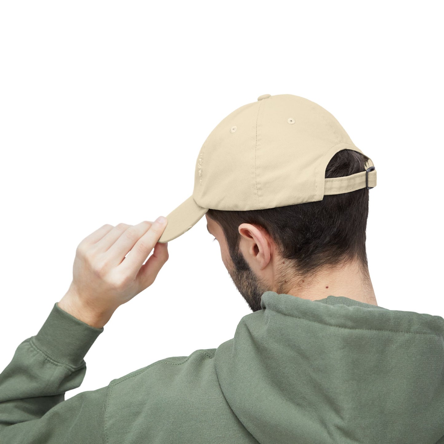 Person wearing a beige Essence Innovation cap and green hoodie on a white background