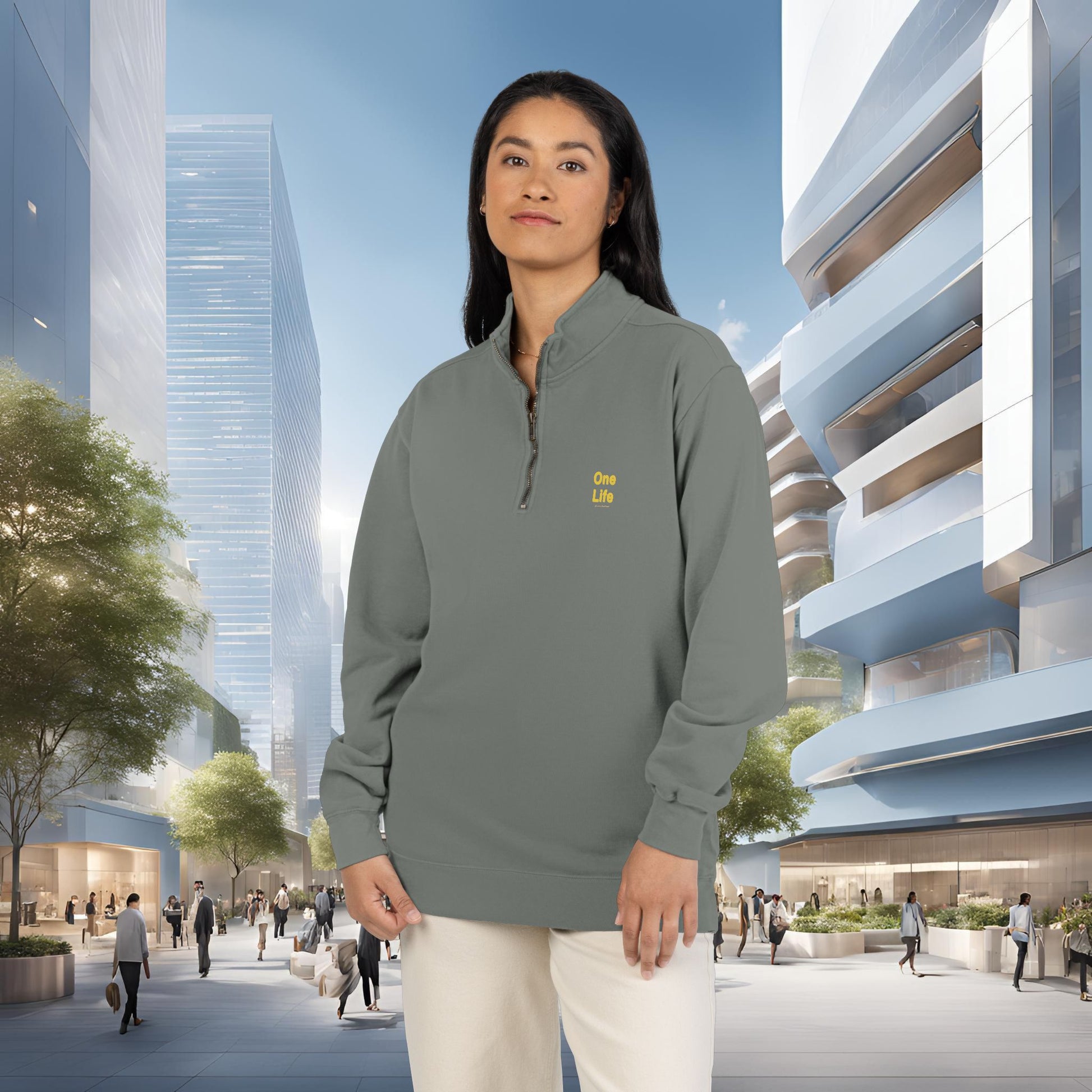 Person wearing a gray pullover with a One Life logo in an urban setting